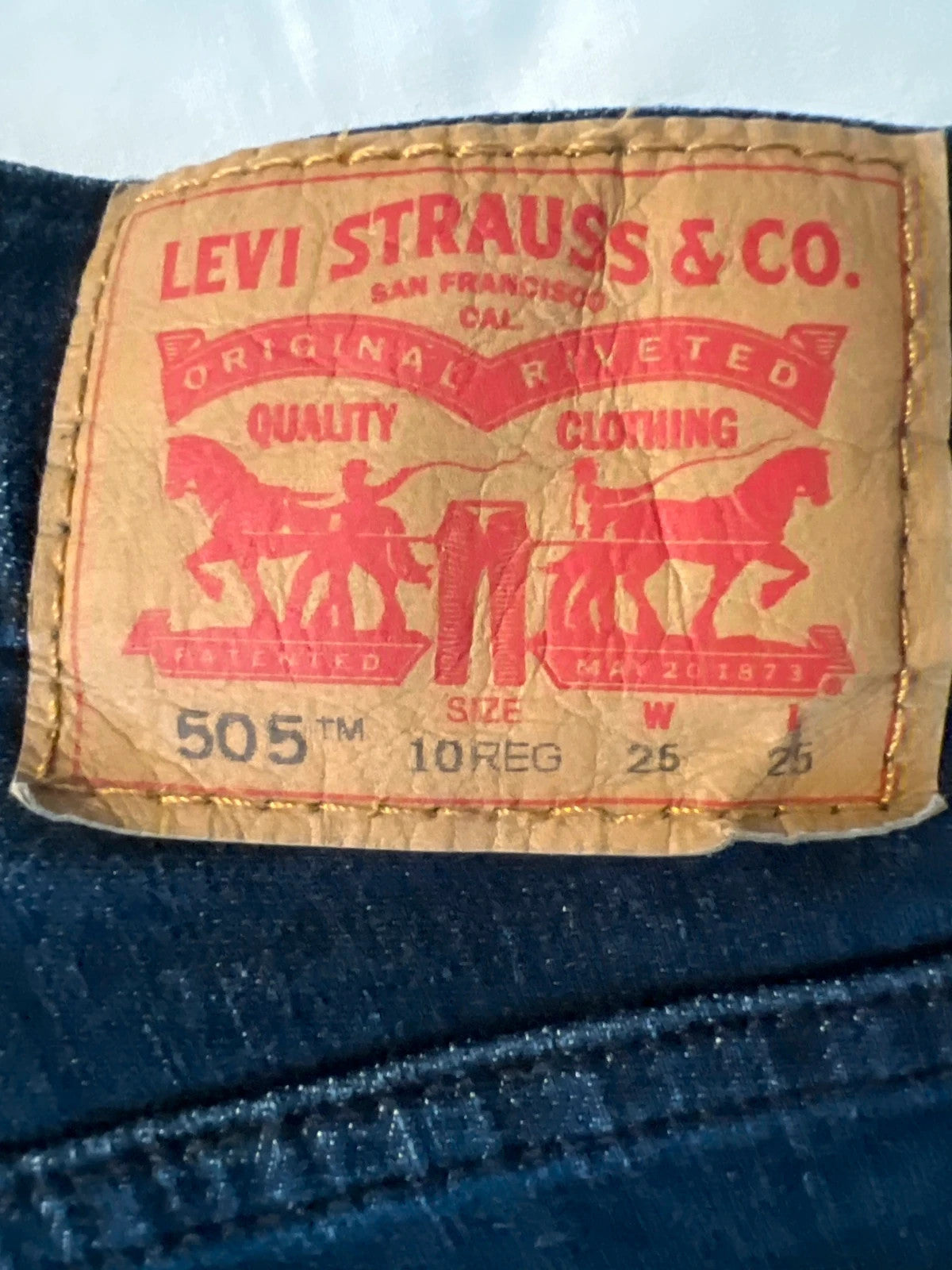 Levi's navy straight jeans with classic 505 logo and denim material.