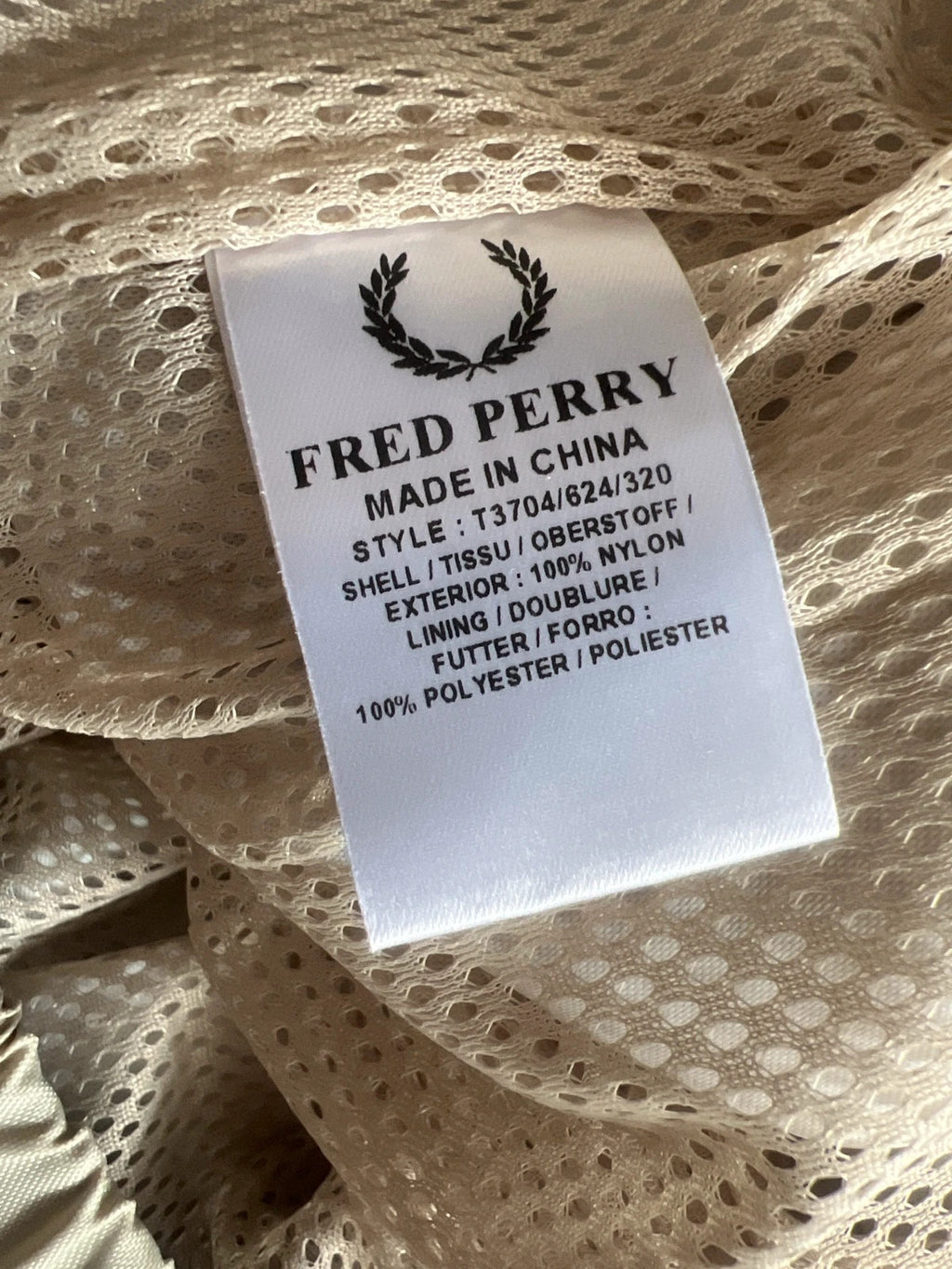 Fred Perry beige wide-leg trousers 100% nylon with logo detail.