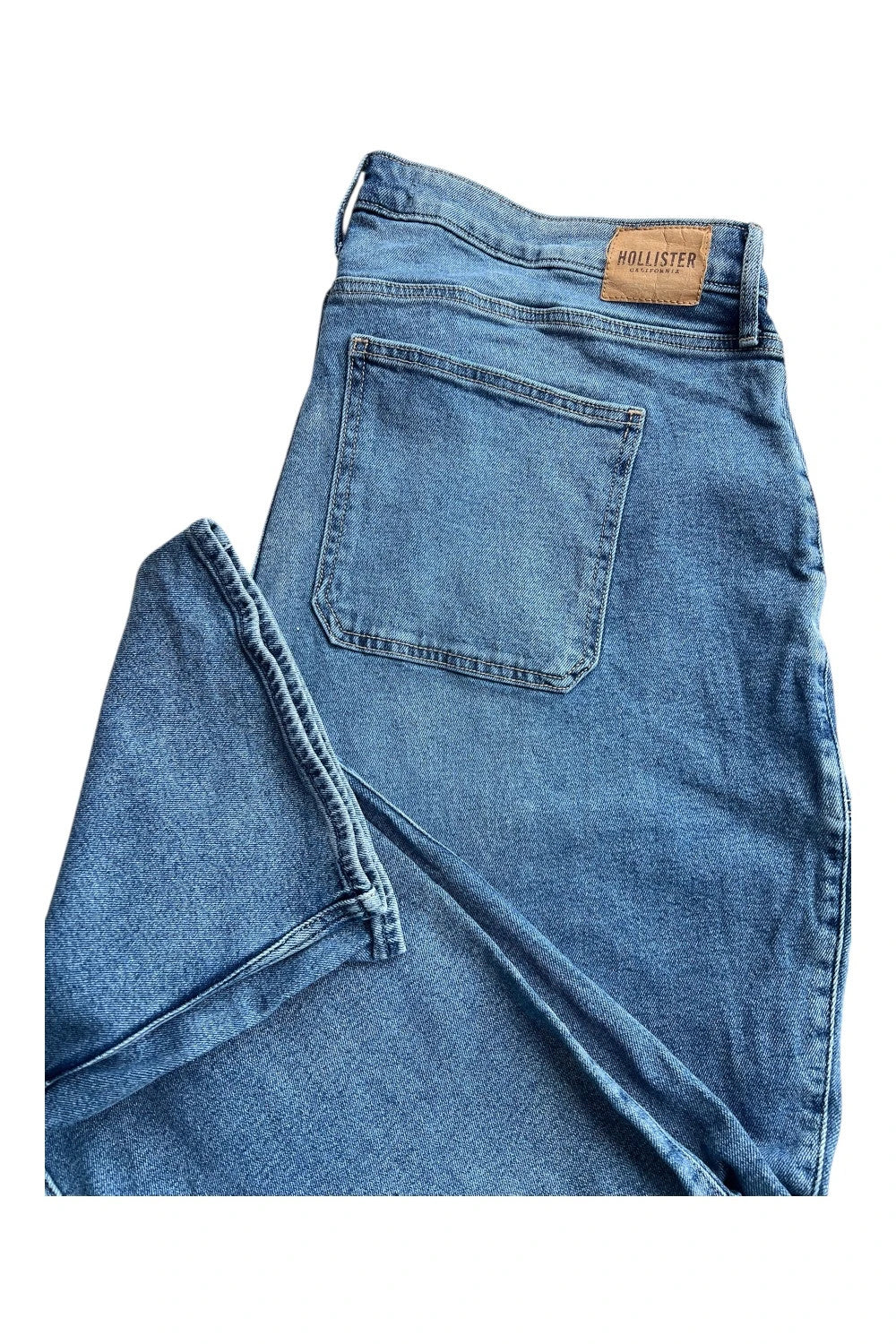 Hollister blue straight jeans relaxed fit vintage baggy style with casual denim texture.