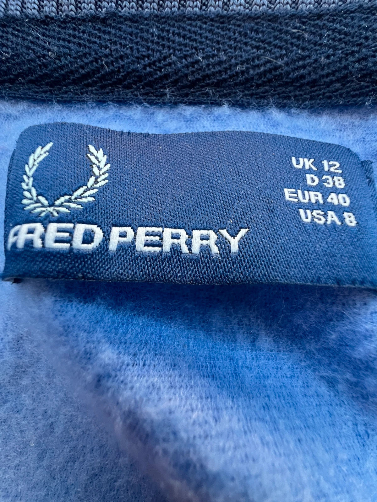 Fred Perry blue Y2K sporty jacket with logo detail and vintage track design.
