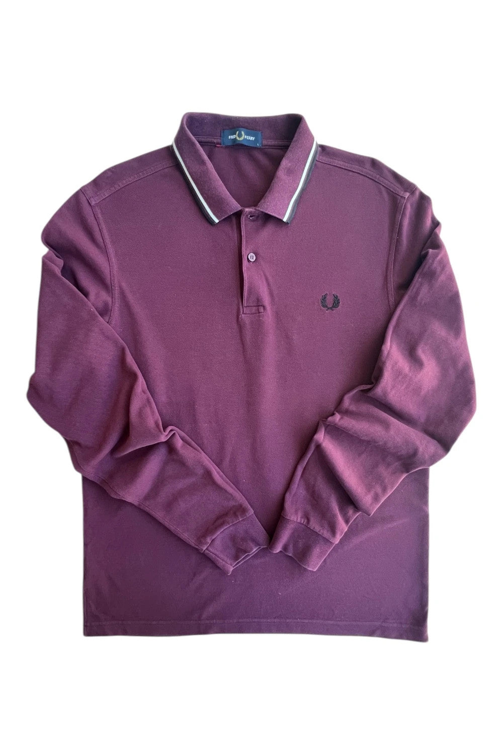 Fred Perry purple long sleeve polo shirt with classic logo and pique texture.