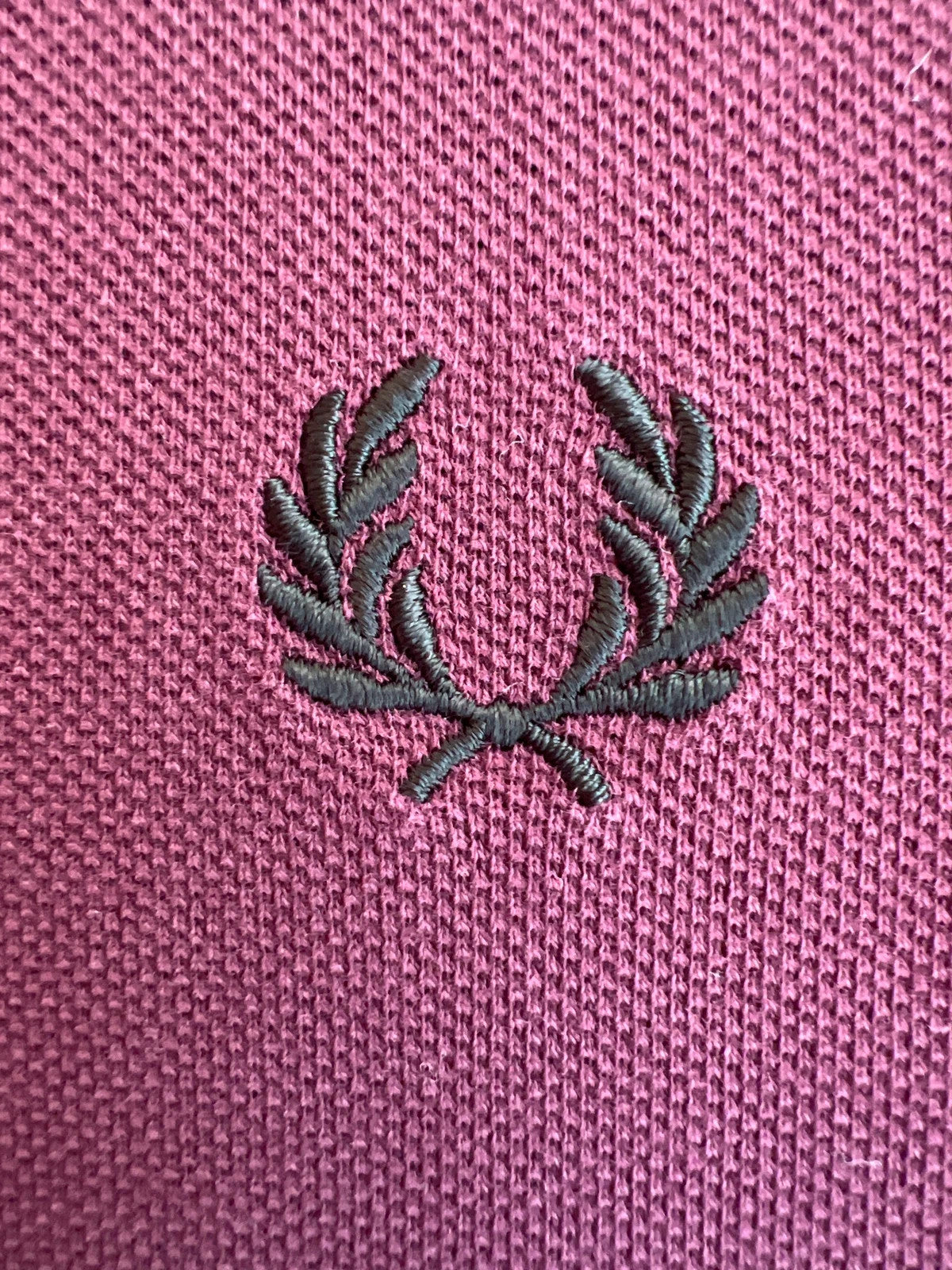 Fred Perry purple long sleeve polo shirt with classic logo and pique texture.