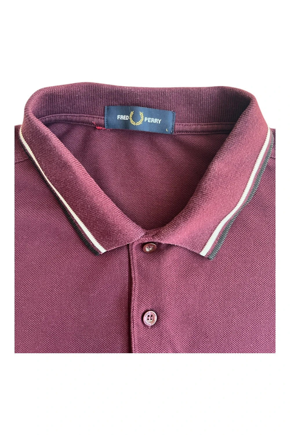 Fred Perry purple long sleeve polo shirt with classic logo and pique texture.
