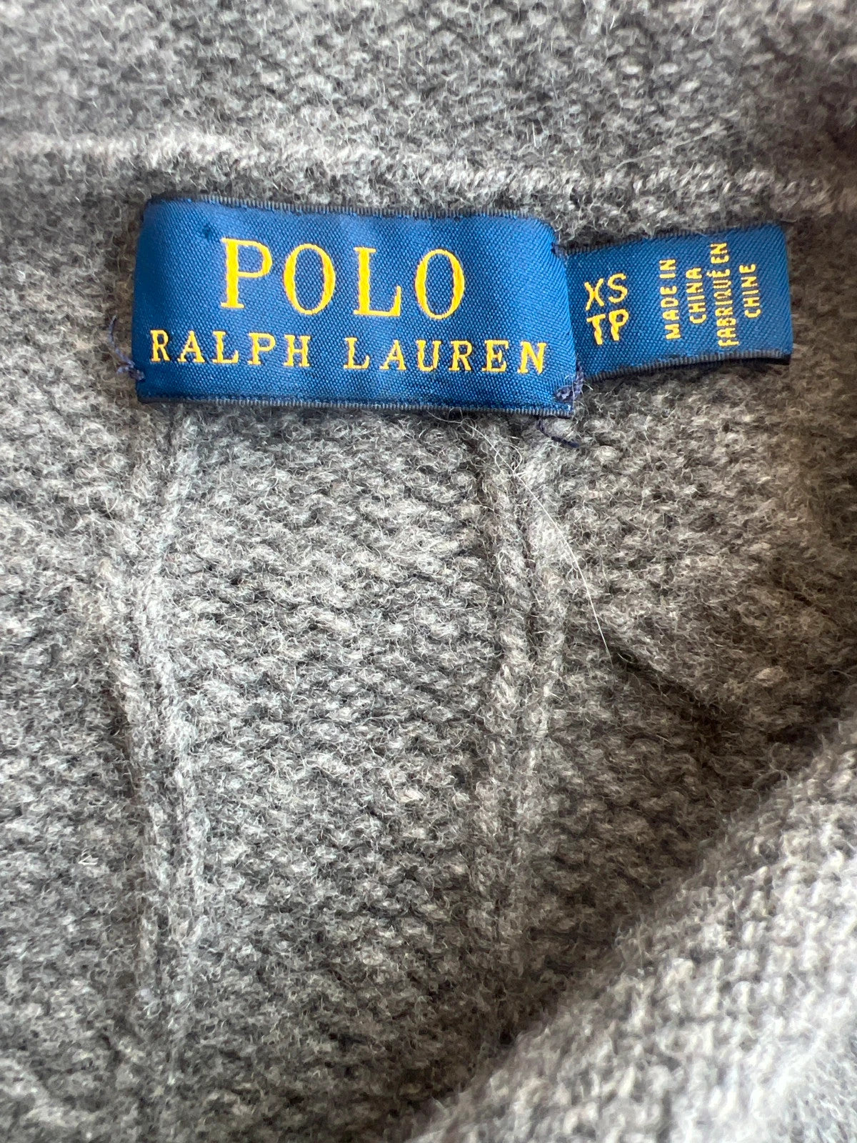 Ralph Lauren grey cable knit cashmere sweater with classic design and premium texture.