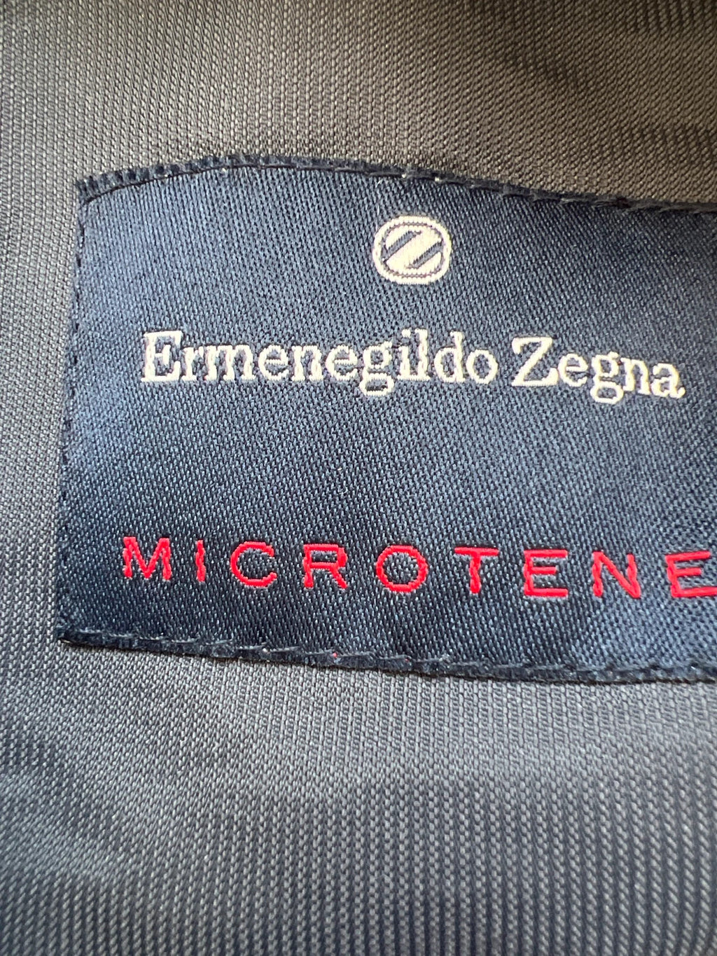 Ermenegildo Zegna grey oversized waterproof jacket with minimalistic design and Microtene material.