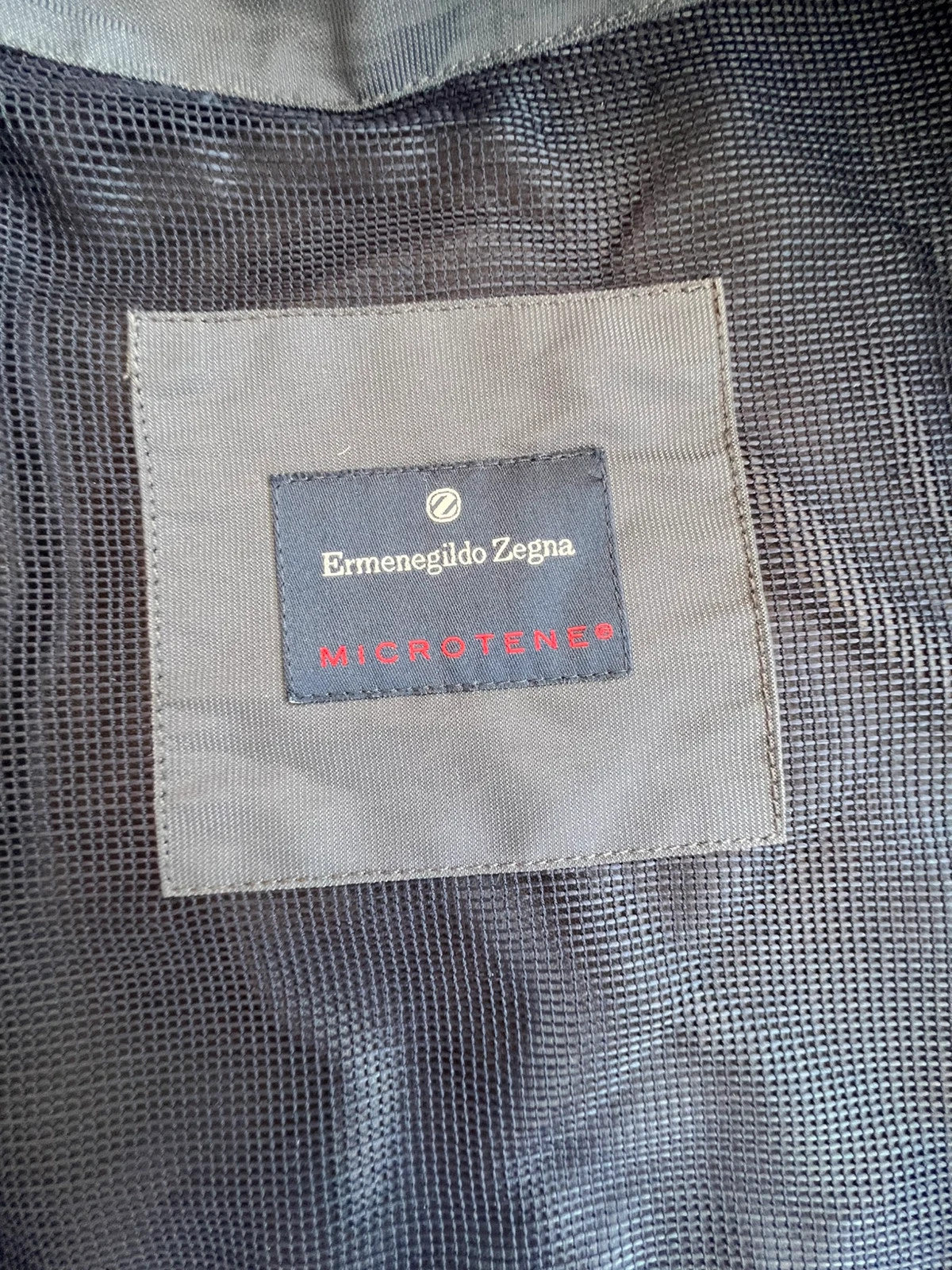 Ermenegildo Zegna grey oversized waterproof jacket with minimalistic design and Microtene material.