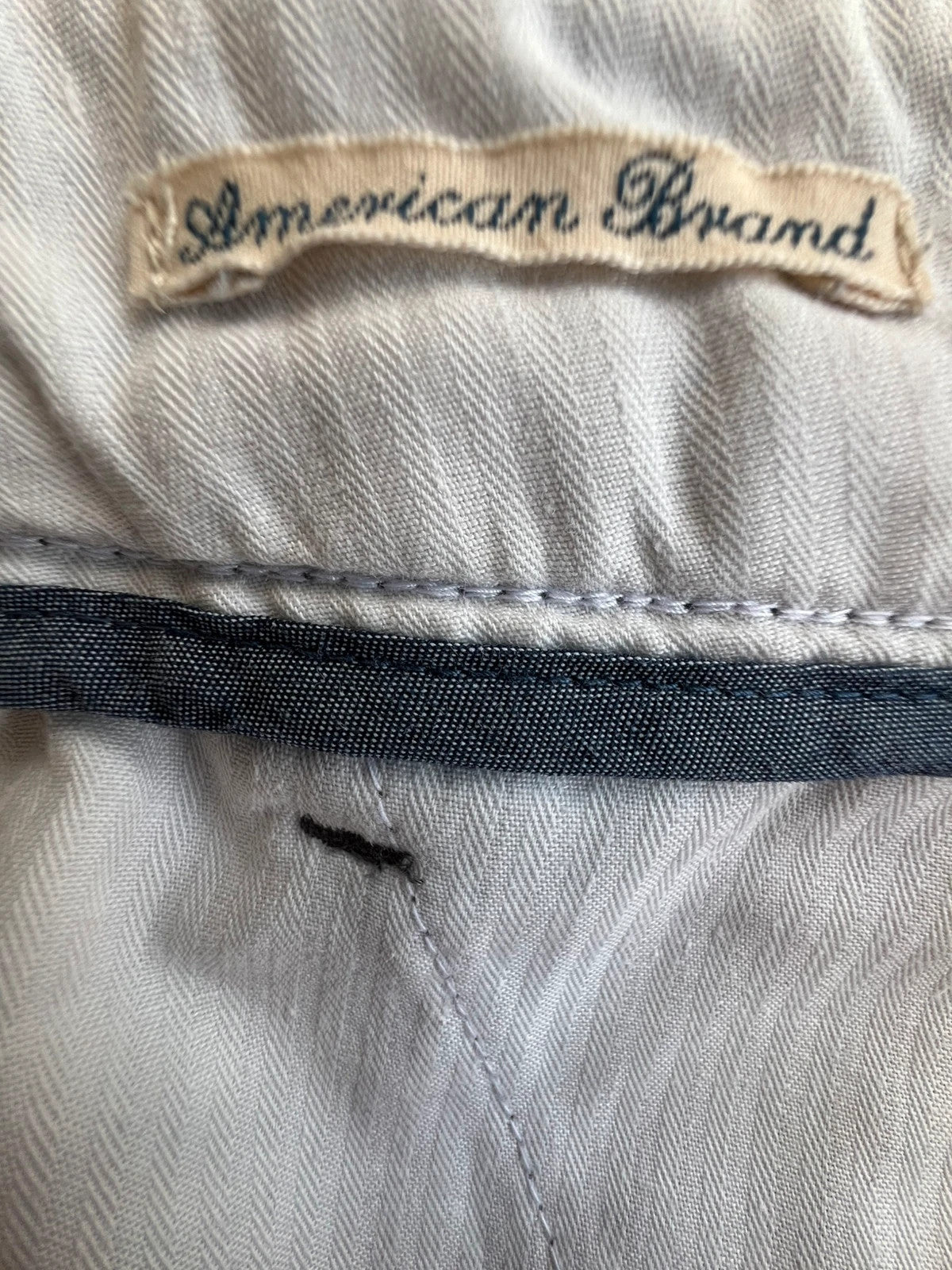 Tommy Hilfiger grey chino trousers with logo tag and soft fabric blend.
