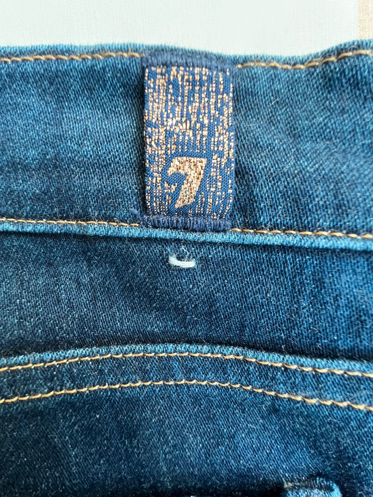 7 For All Mankind navy skinny jeans with elastic denim fabric and classic logo.