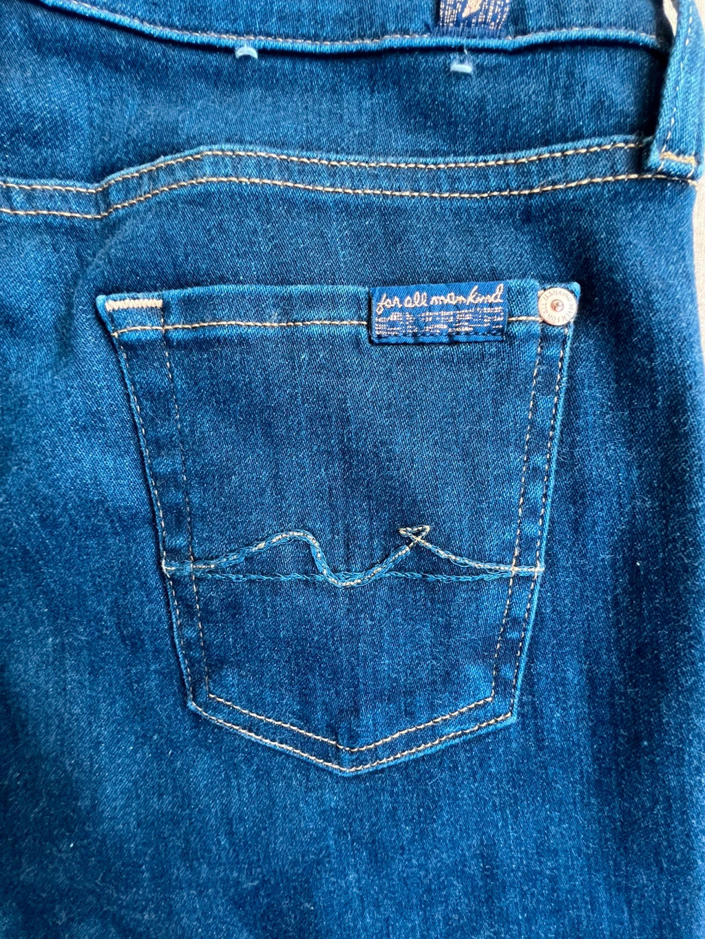 7 For All Mankind navy skinny jeans with elastic denim fabric and classic logo.