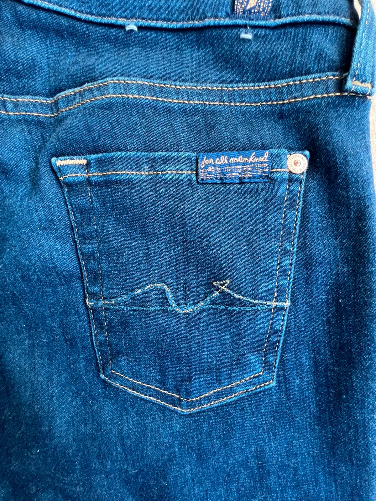 7 For All Mankind navy skinny jeans with elastic denim fabric and classic logo.