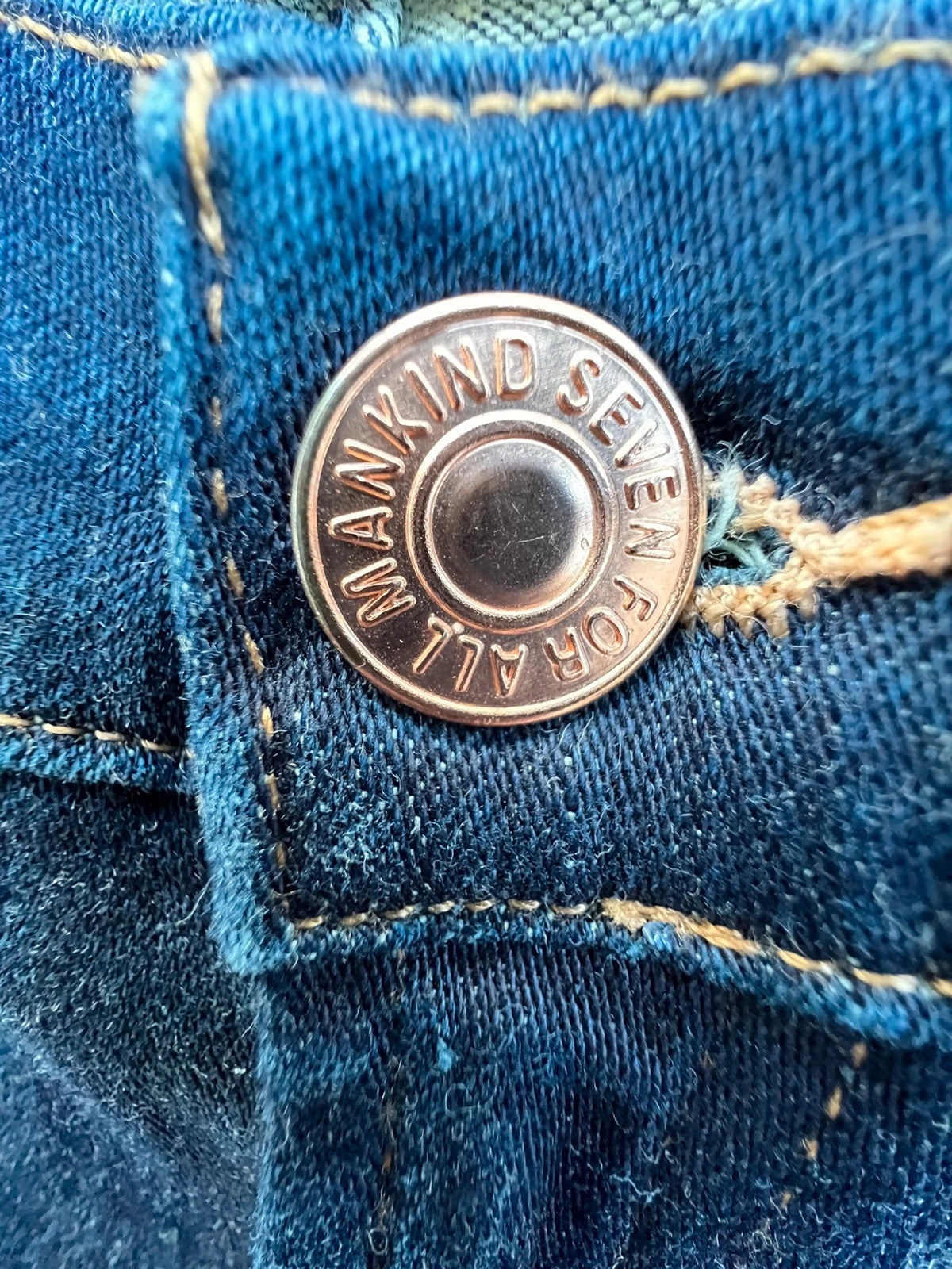 7 For All Mankind navy skinny jeans with elastic denim fabric and classic logo.