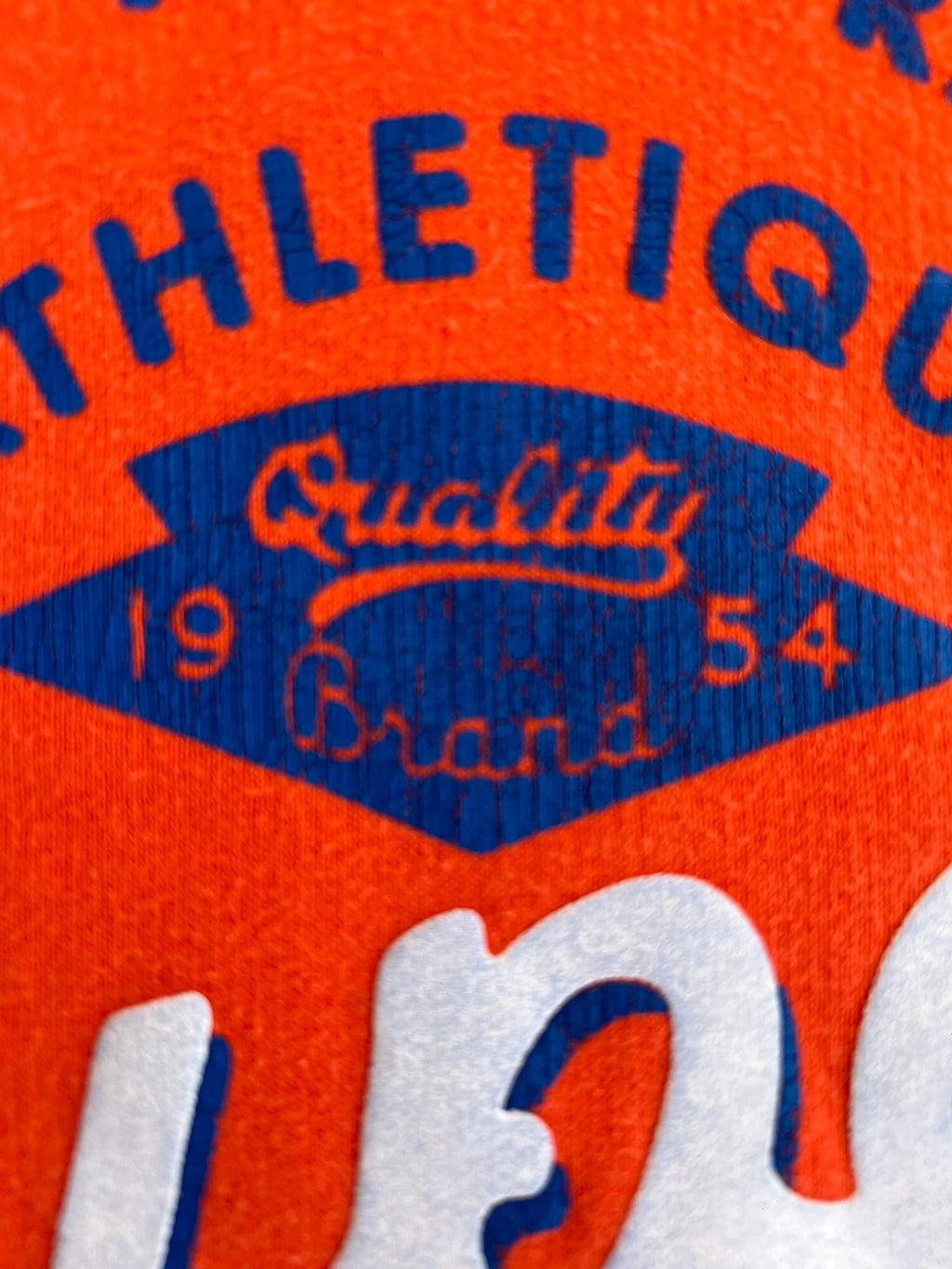 Superdry orange oversized hoodie with large vintage logo and casual streetwear style.