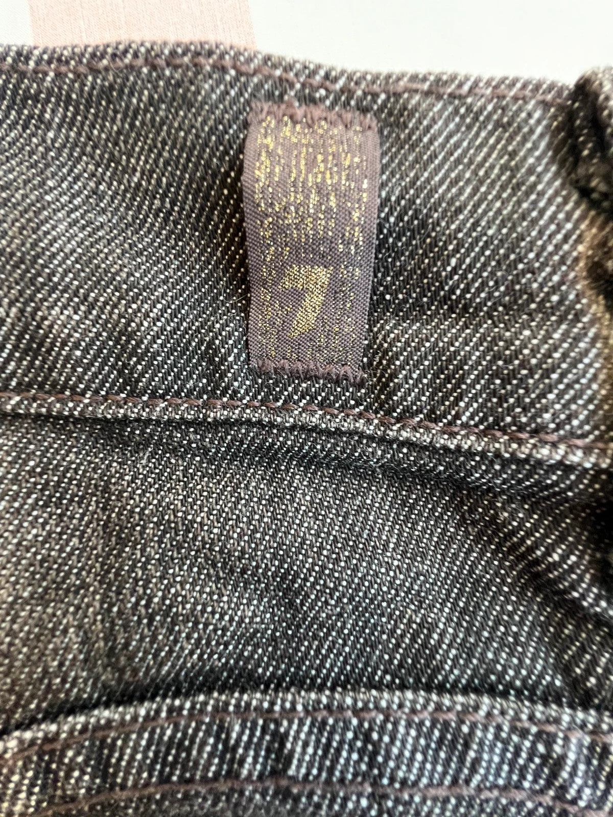 7 For All Mankind brown skinny jeans with premium denim and minimalistic design.