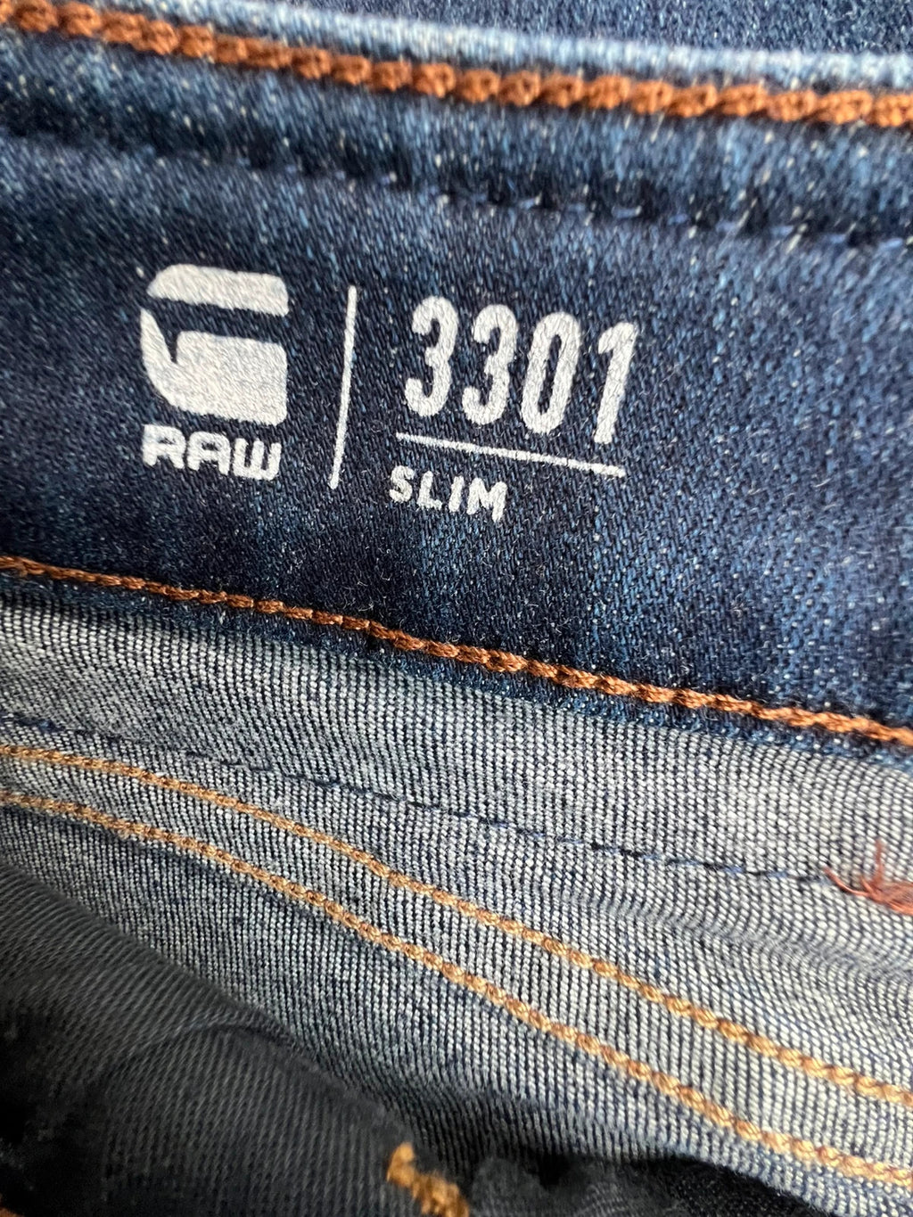 G-Star blue slim jeans 3301 with classic style and denim material.