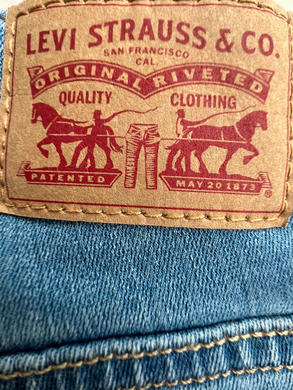 Levi's blue straight jeans with elastic denim, classic logo, slim fit design.