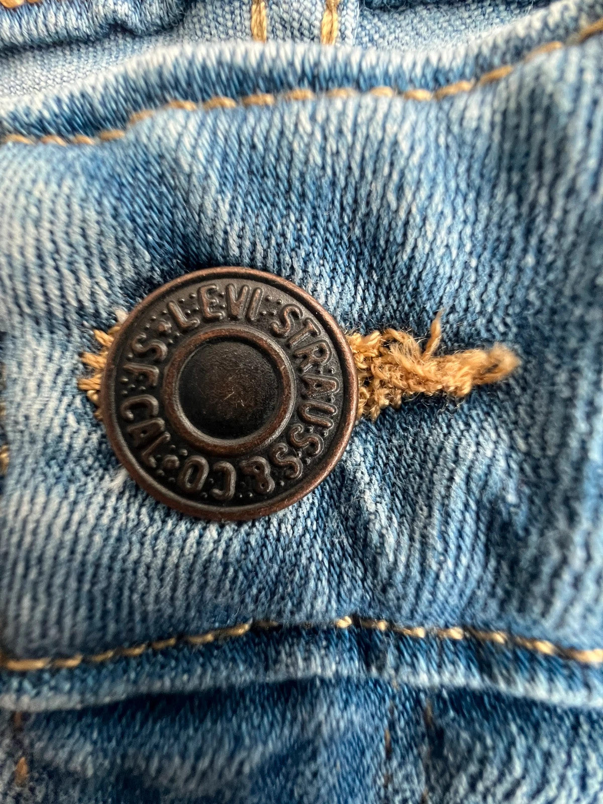 Levi's blue straight jeans with elastic denim, classic logo, slim fit design.