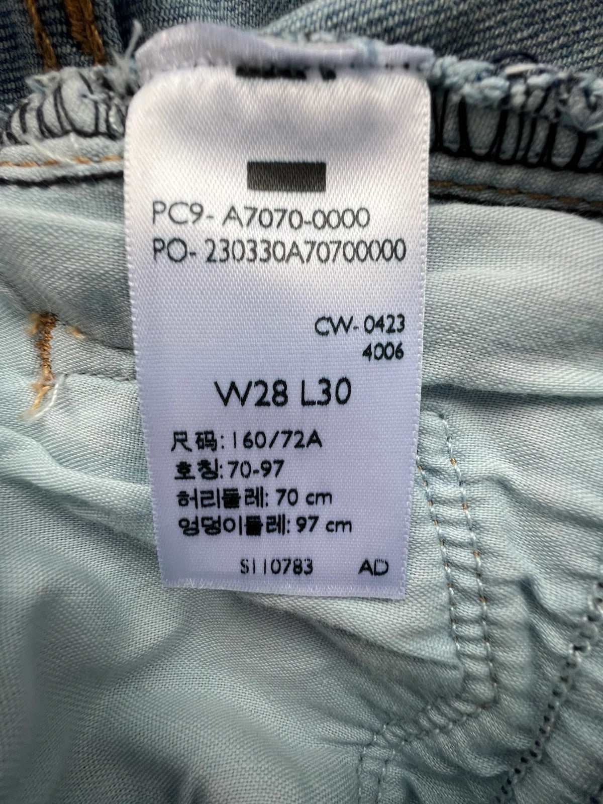 Levi's blue straight jeans with elastic denim, classic logo, slim fit design.