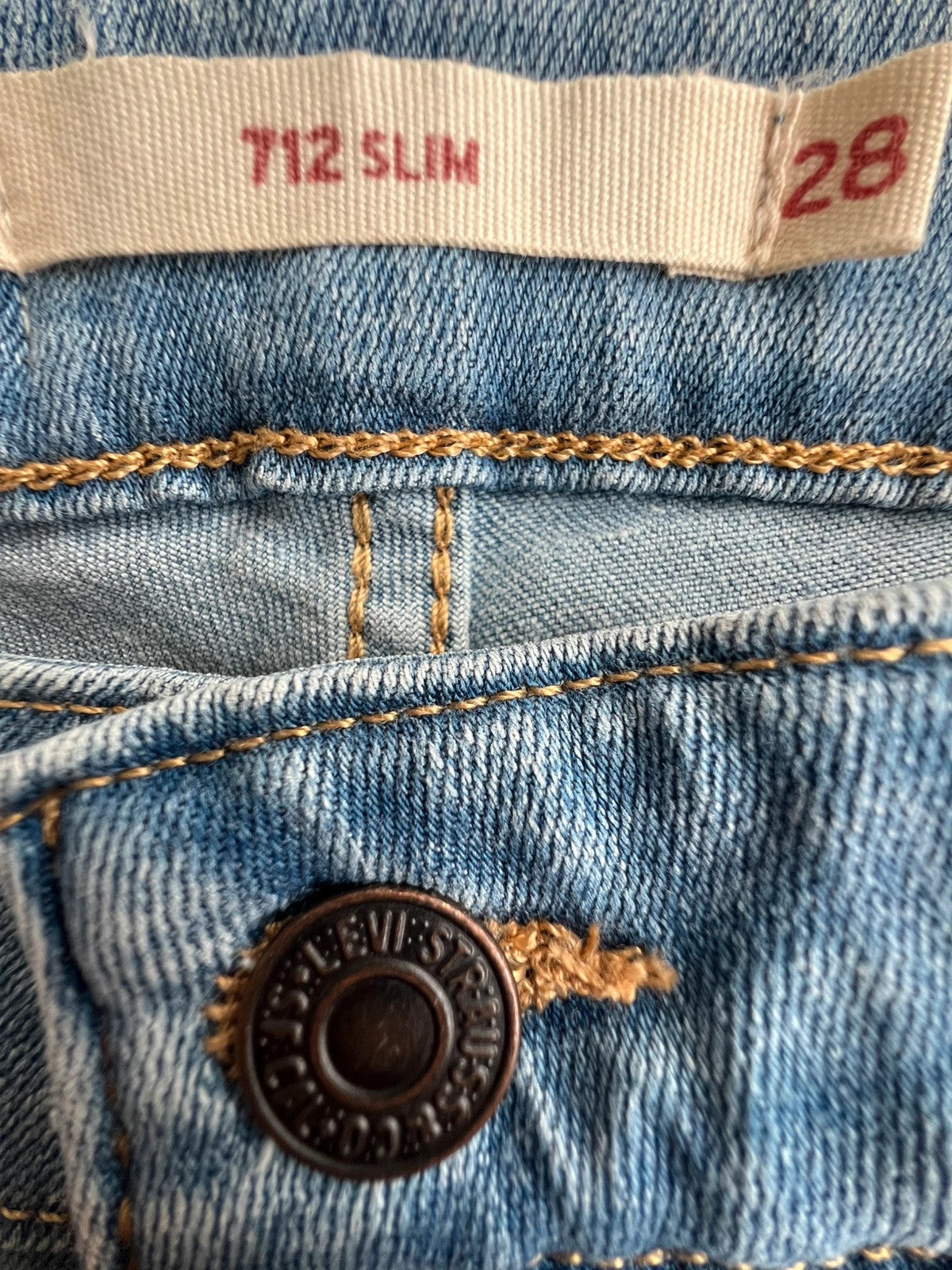 Levi's blue straight jeans with elastic denim, classic logo, slim fit design.