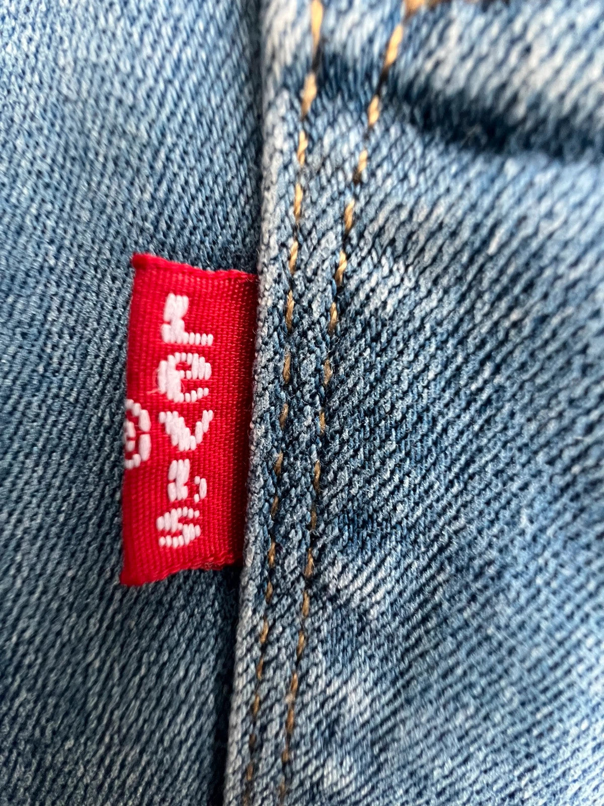 Levi's blue straight jeans with elastic denim, classic logo, slim fit design.