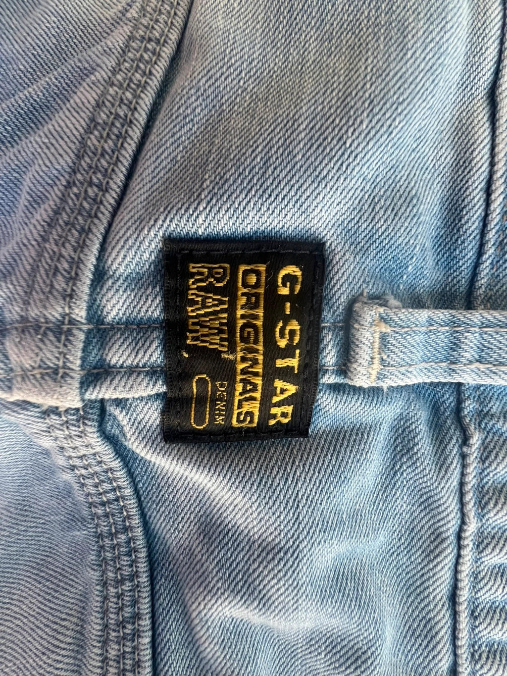 G-Star light blue straight jeans with subtle wear, Y2K style, and logo details.