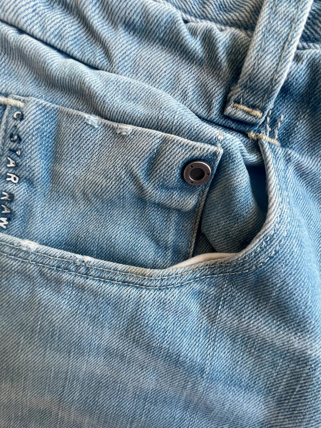G-Star light blue straight jeans with subtle wear, Y2K style, and logo details.