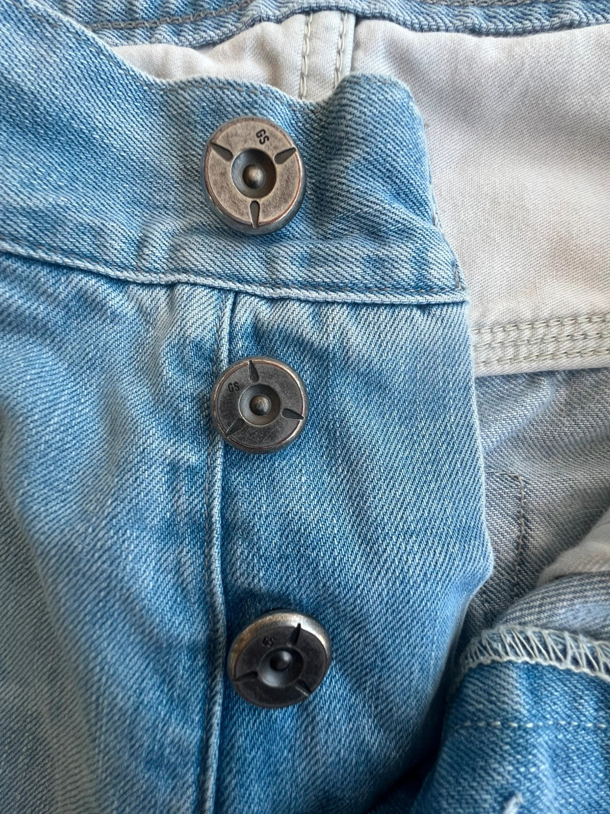 G-Star light blue straight jeans with subtle wear, Y2K style, and logo details.
