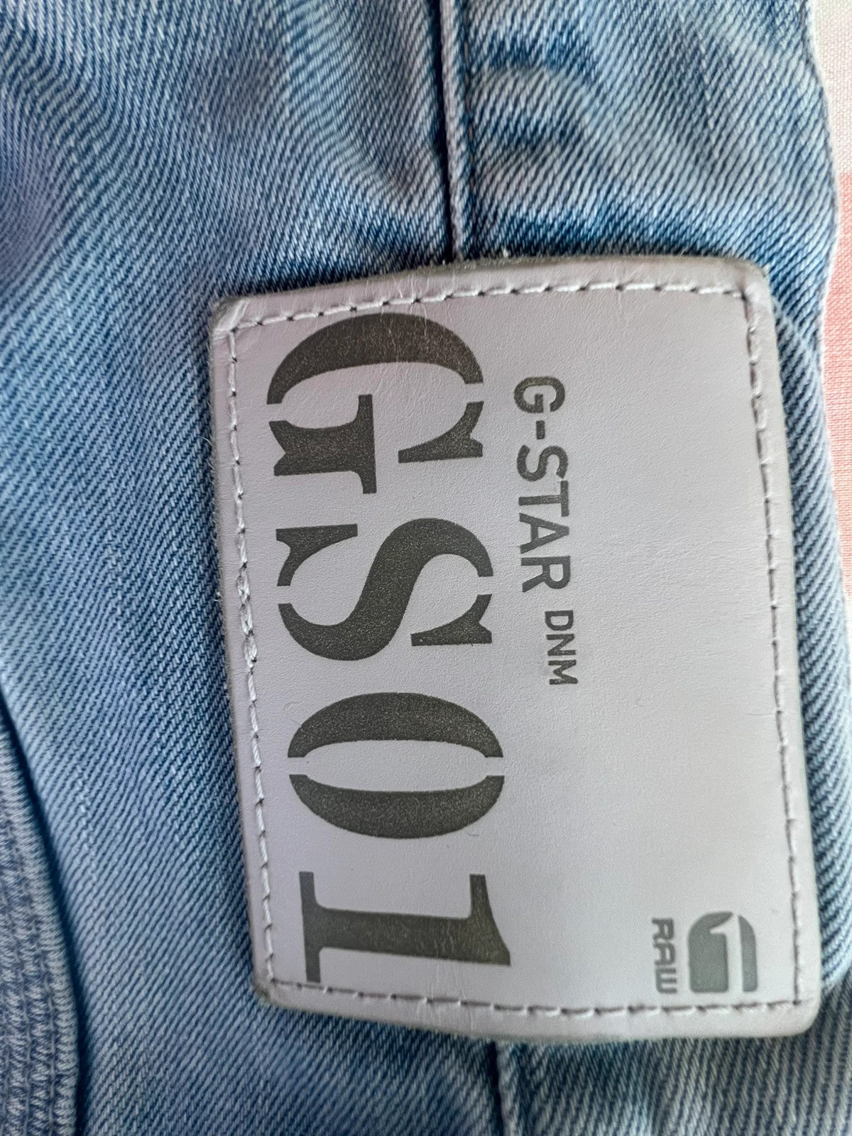 G-Star light blue straight jeans with subtle wear, Y2K style, and logo details.