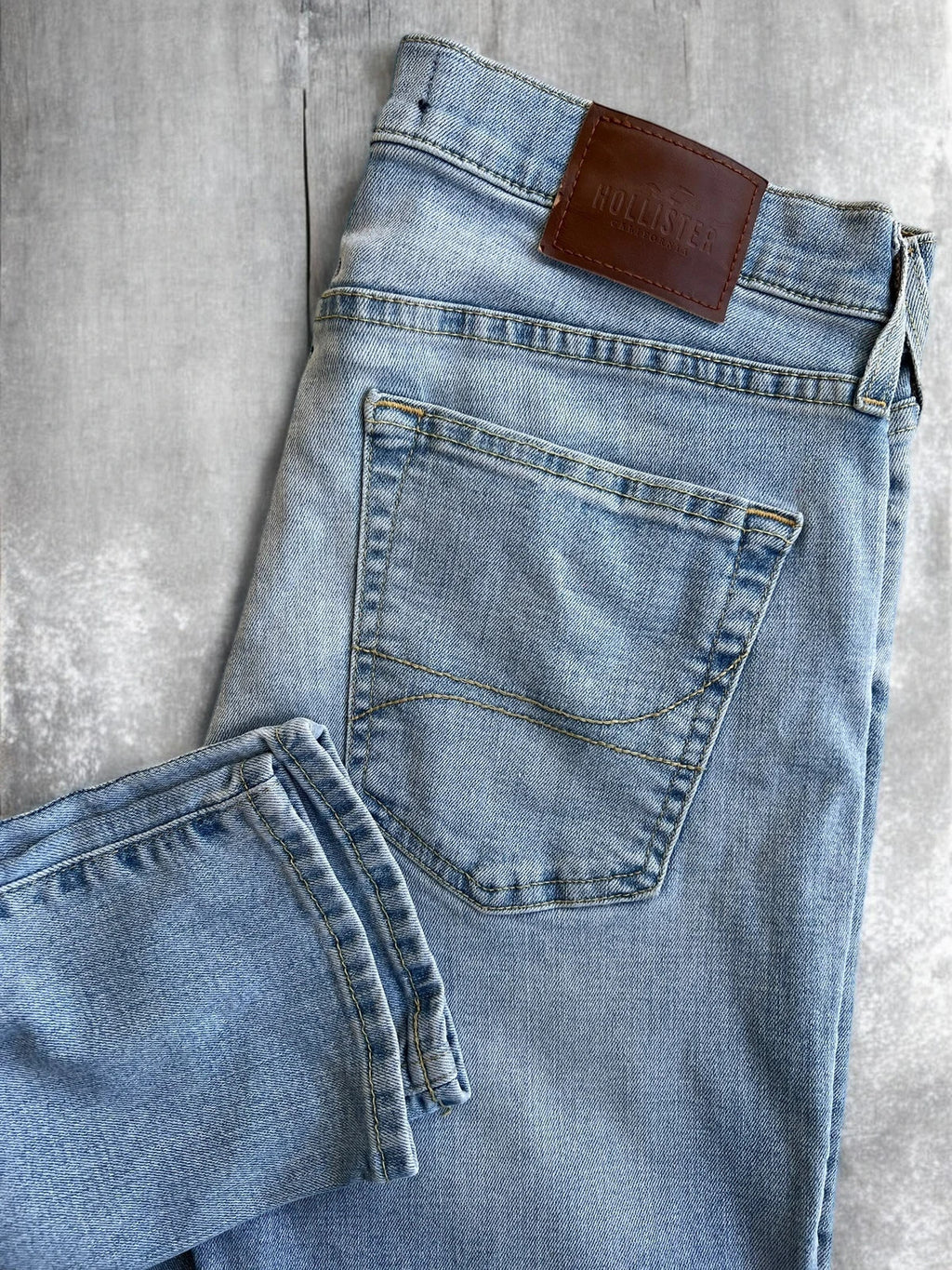 Hollister blue slim straight jeans with casual style and light denim wash.