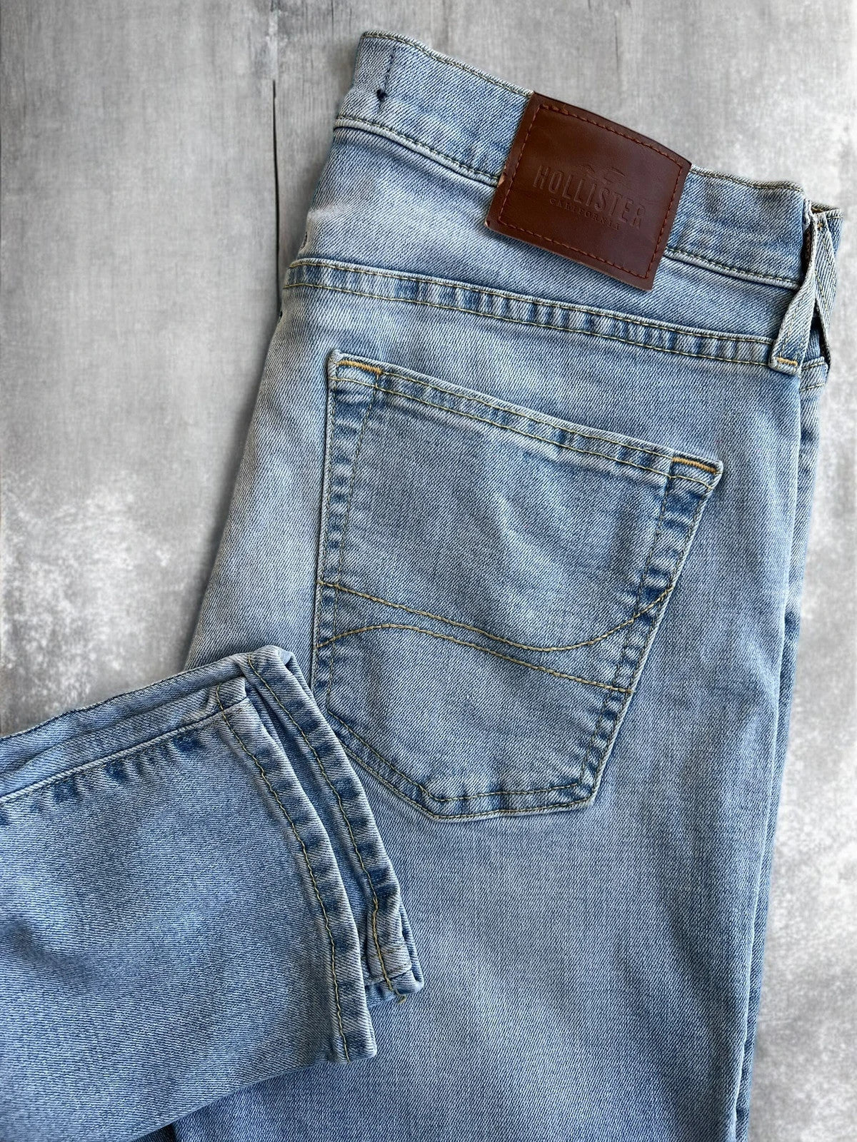 Hollister blue slim straight jeans with casual style and light denim wash.