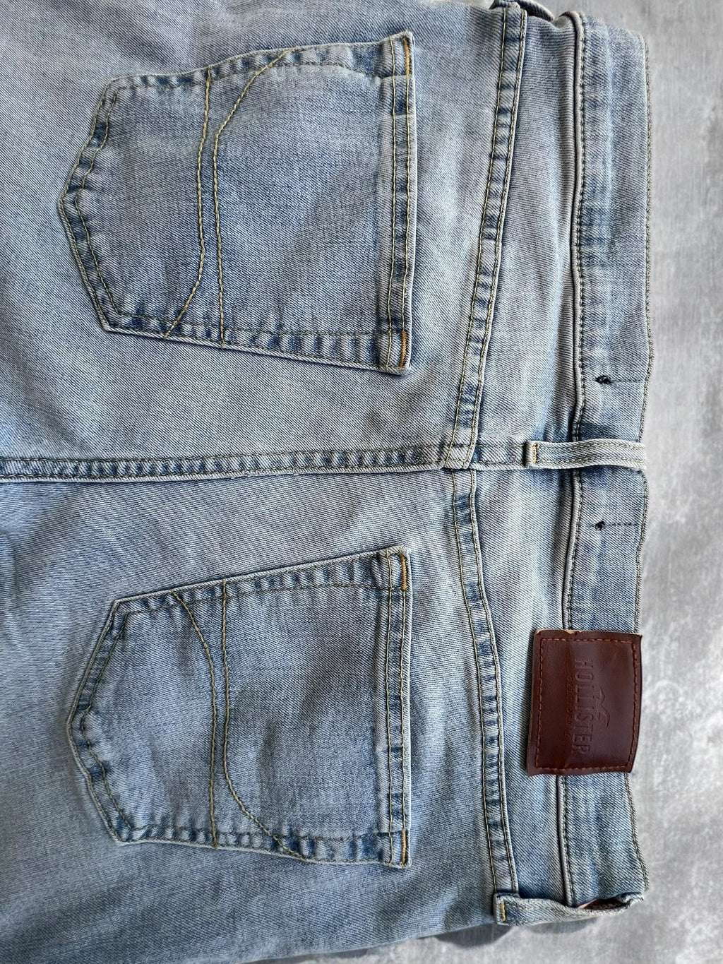 Hollister blue slim straight jeans with casual style and light denim wash.
