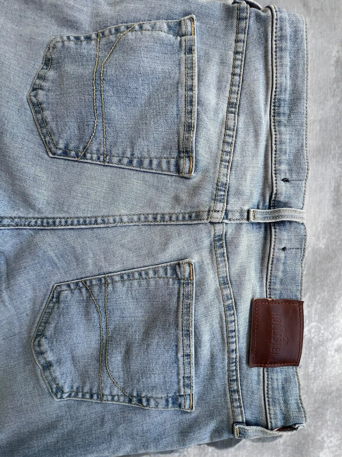 Hollister blue slim straight jeans with casual style and light denim wash.