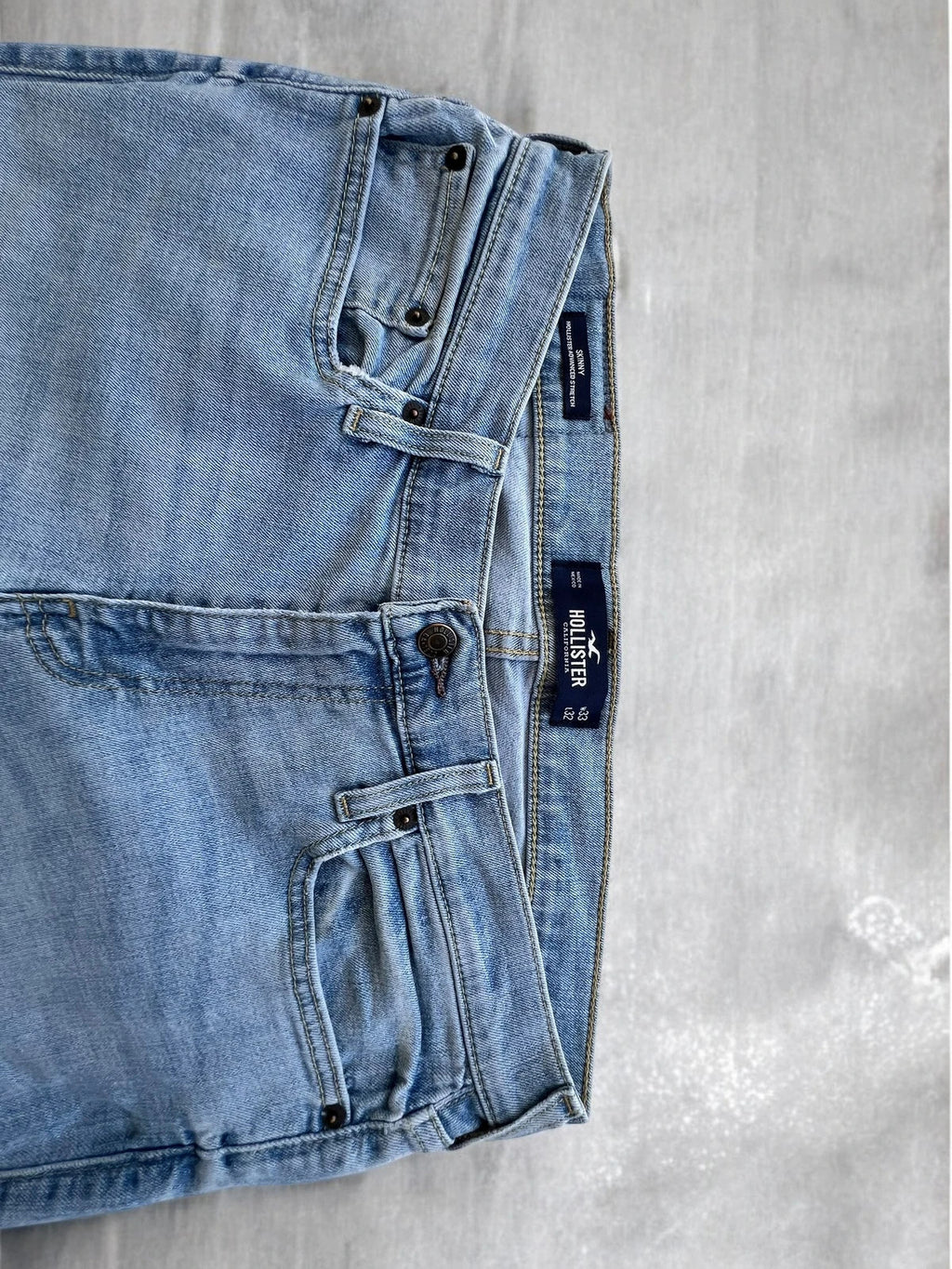 Hollister blue slim straight jeans with casual style and light denim wash.
