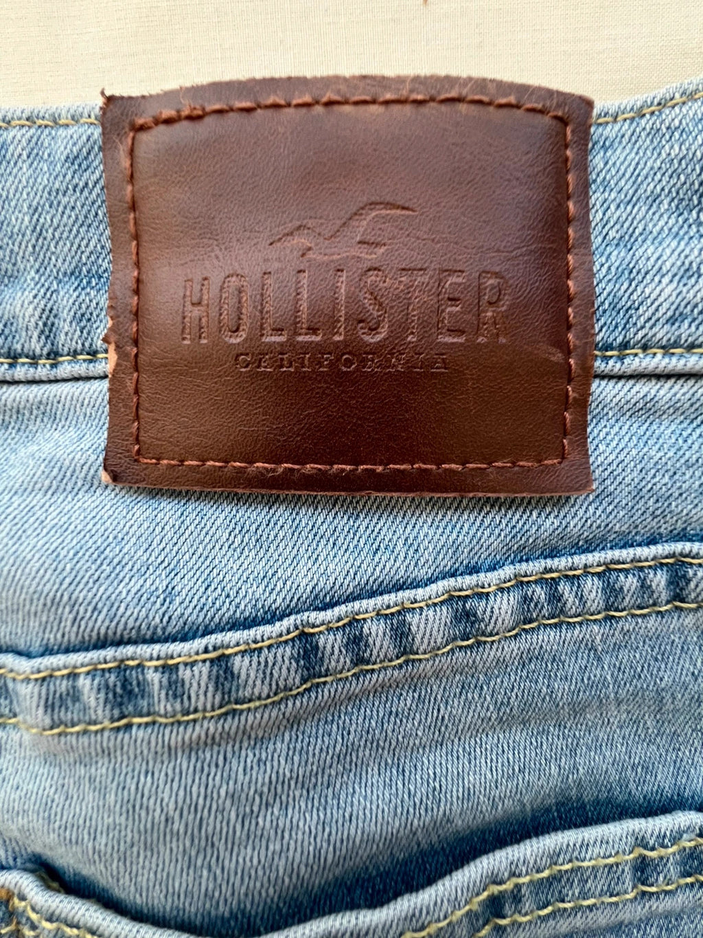 Hollister blue slim straight jeans with casual style and light denim wash.