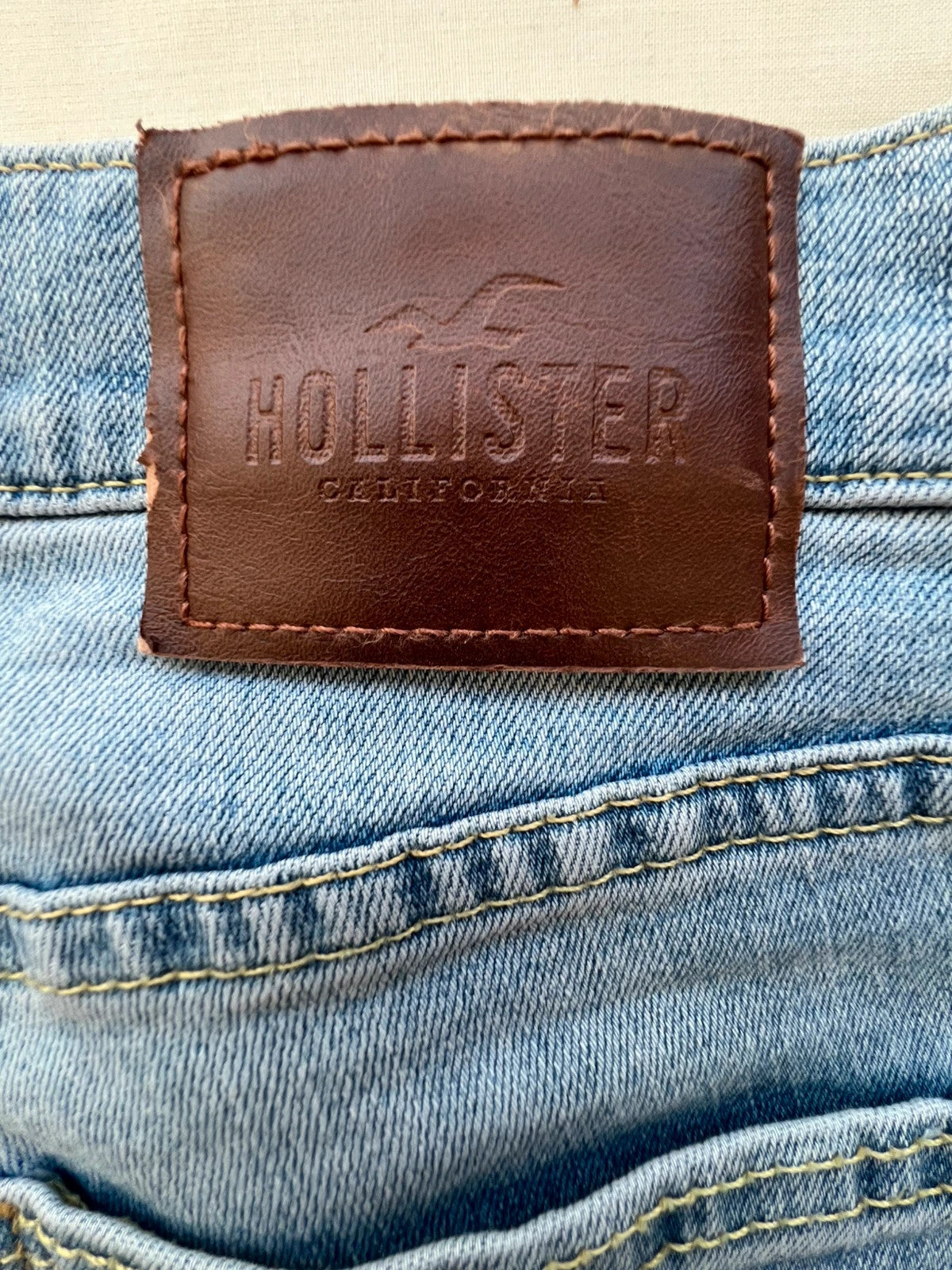 Hollister blue slim straight jeans with casual style and light denim wash.
