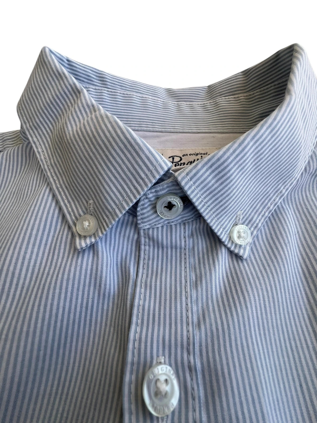 Penguin blue and white striped button down shirt with casual collar and subtle imperfections.