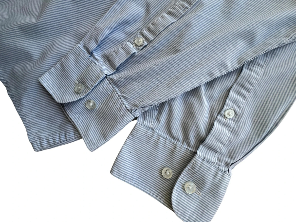 Penguin blue and white striped button down shirt with casual collar and subtle imperfections.