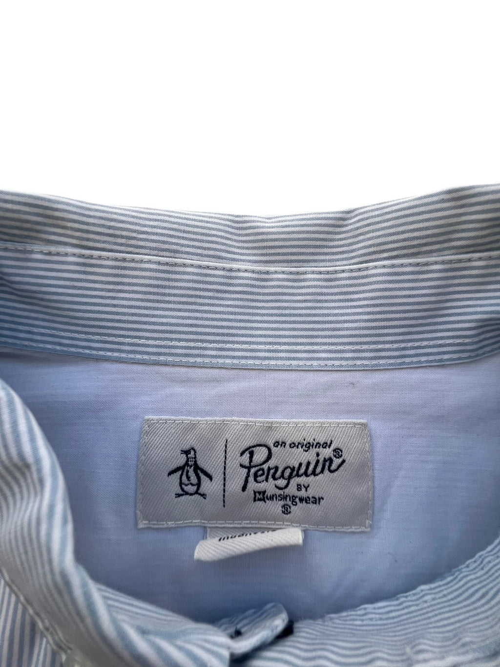 Penguin blue and white striped button down shirt with casual collar and subtle imperfections.