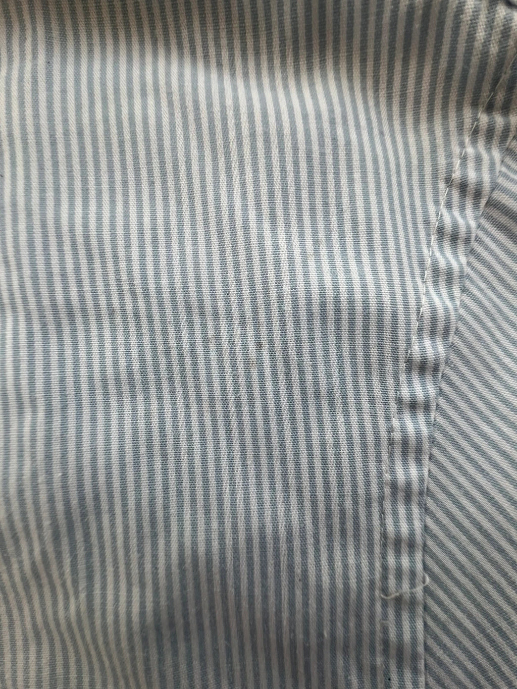 Penguin blue and white striped button down shirt with casual collar and subtle imperfections.