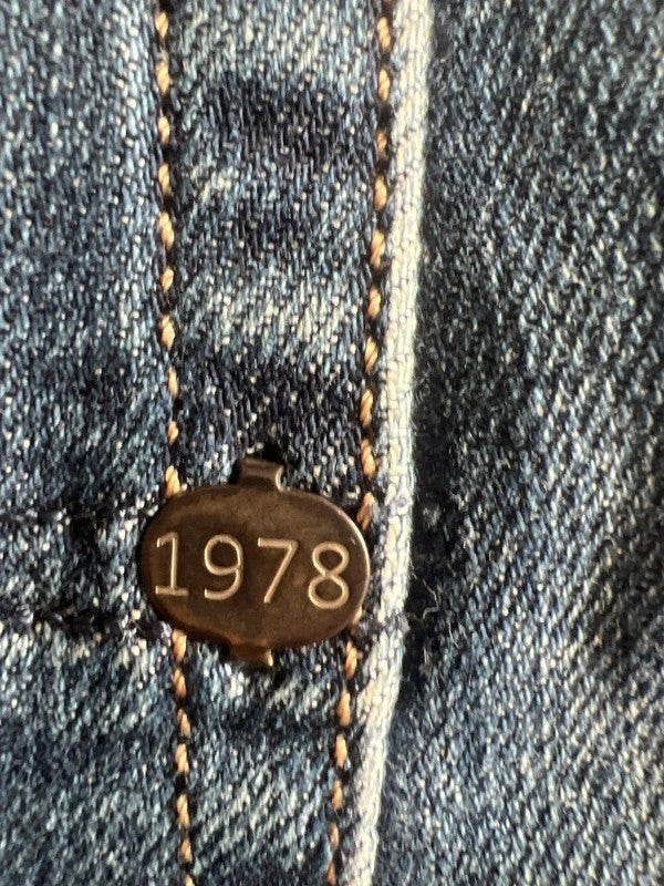 Diesel blue slim straight jeans with logo patch and classic denim texture.