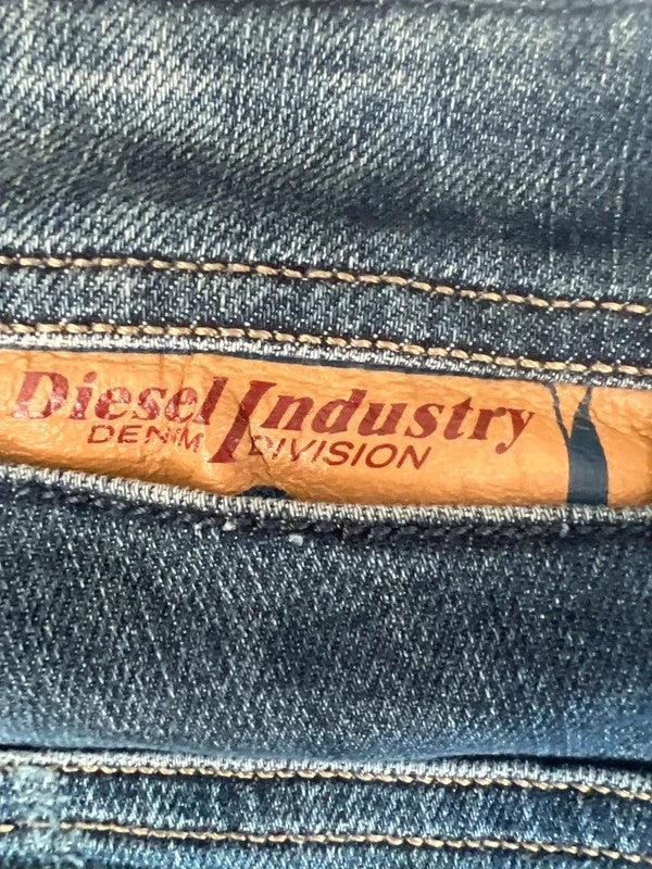 Diesel blue slim straight jeans with logo patch and classic denim texture.