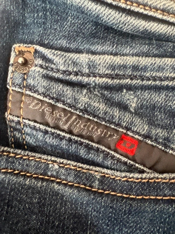 Diesel blue slim straight jeans with logo patch and classic denim texture.