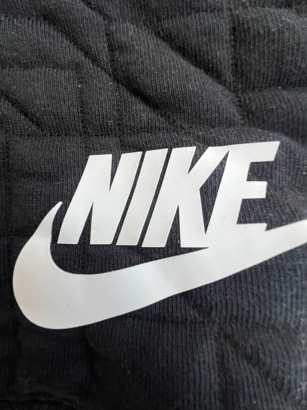 Nike black quilted sweatshirt vintage style with white logo, perfect for streetwear.