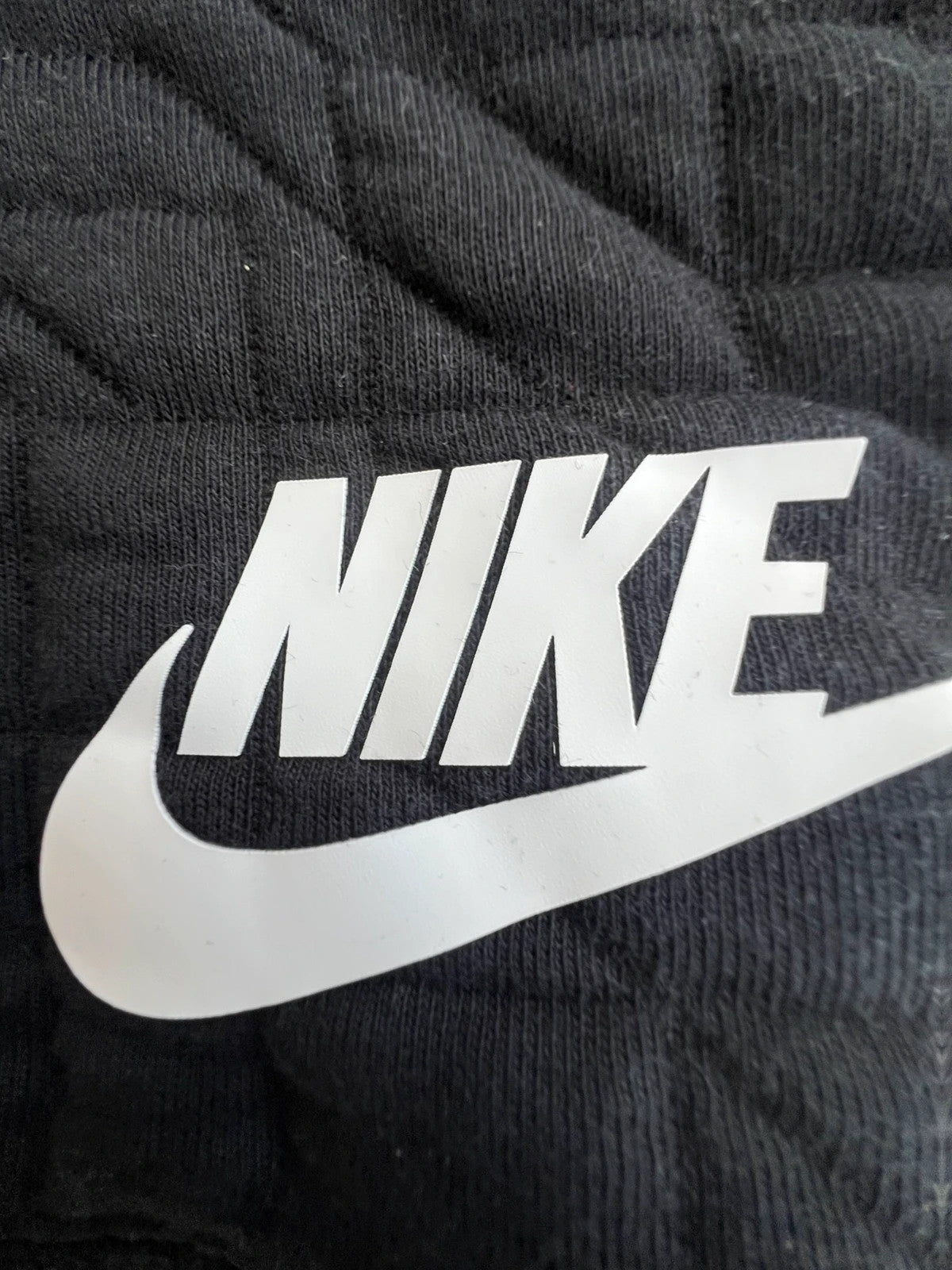 Nike black quilted sweatshirt vintage style with white logo, perfect for streetwear.
