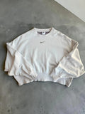 Nike cream cropped sweatshirt with embroidered mini swoosh logo, oversized fit.