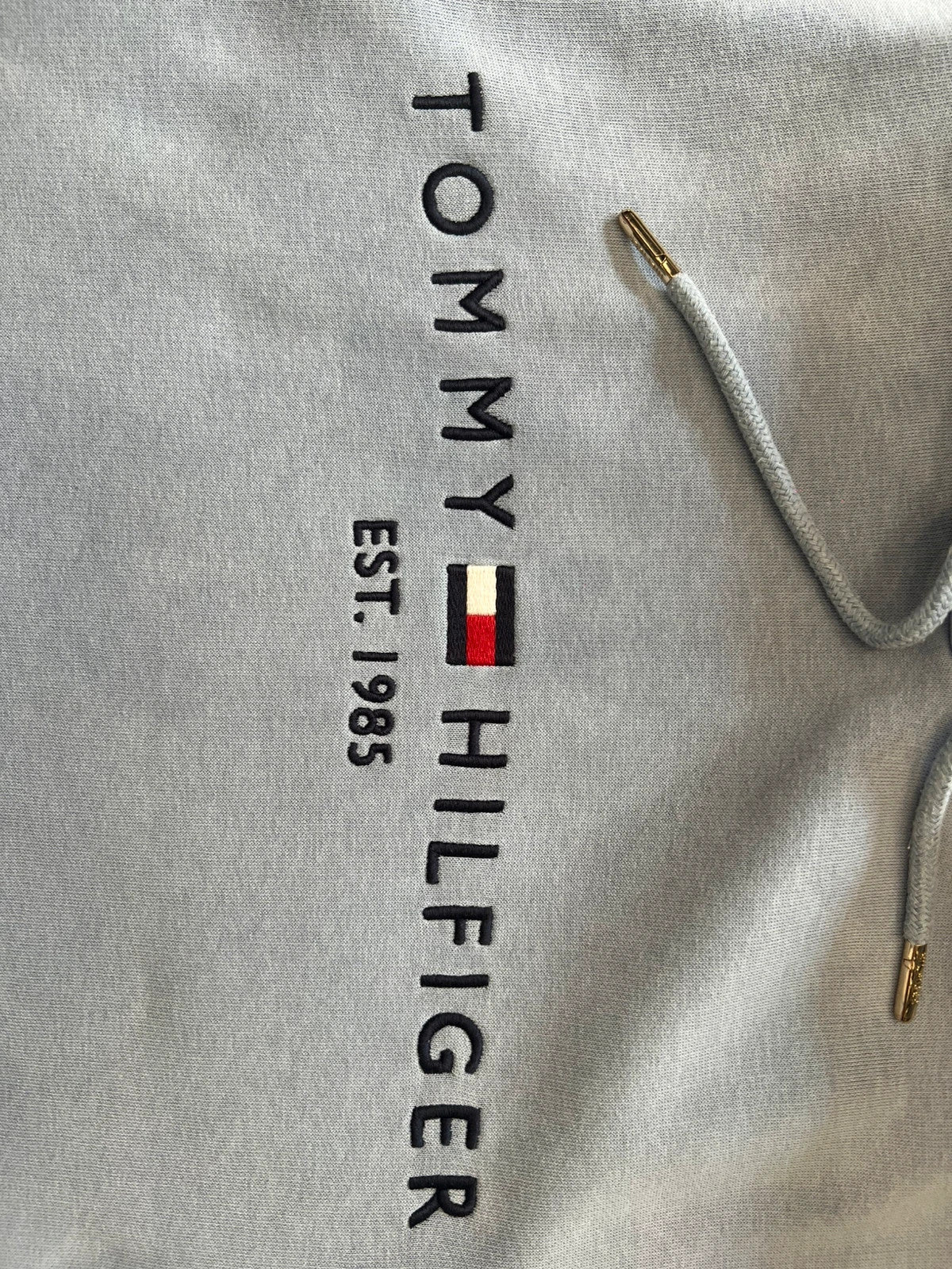 Tommy Hilfiger blue hoodie with embroidered logo and adjustable hood, soft interior.