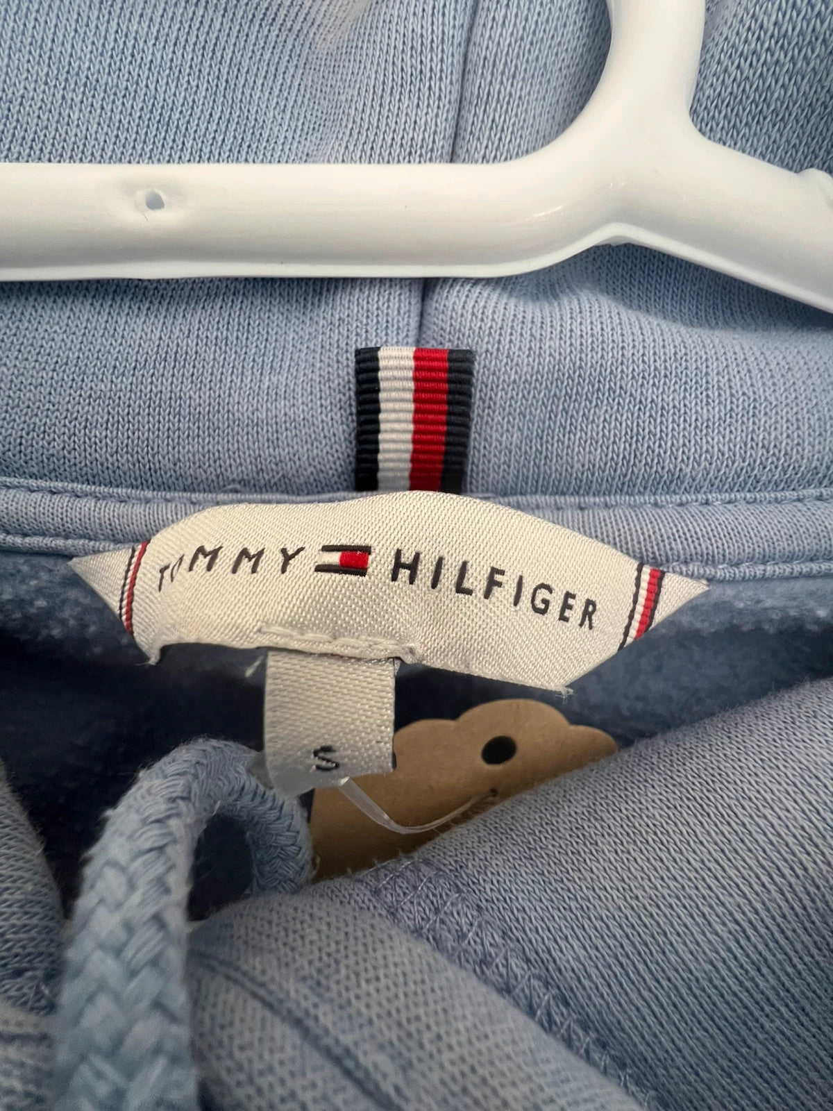 Tommy Hilfiger blue hoodie with embroidered logo and adjustable hood, soft interior.