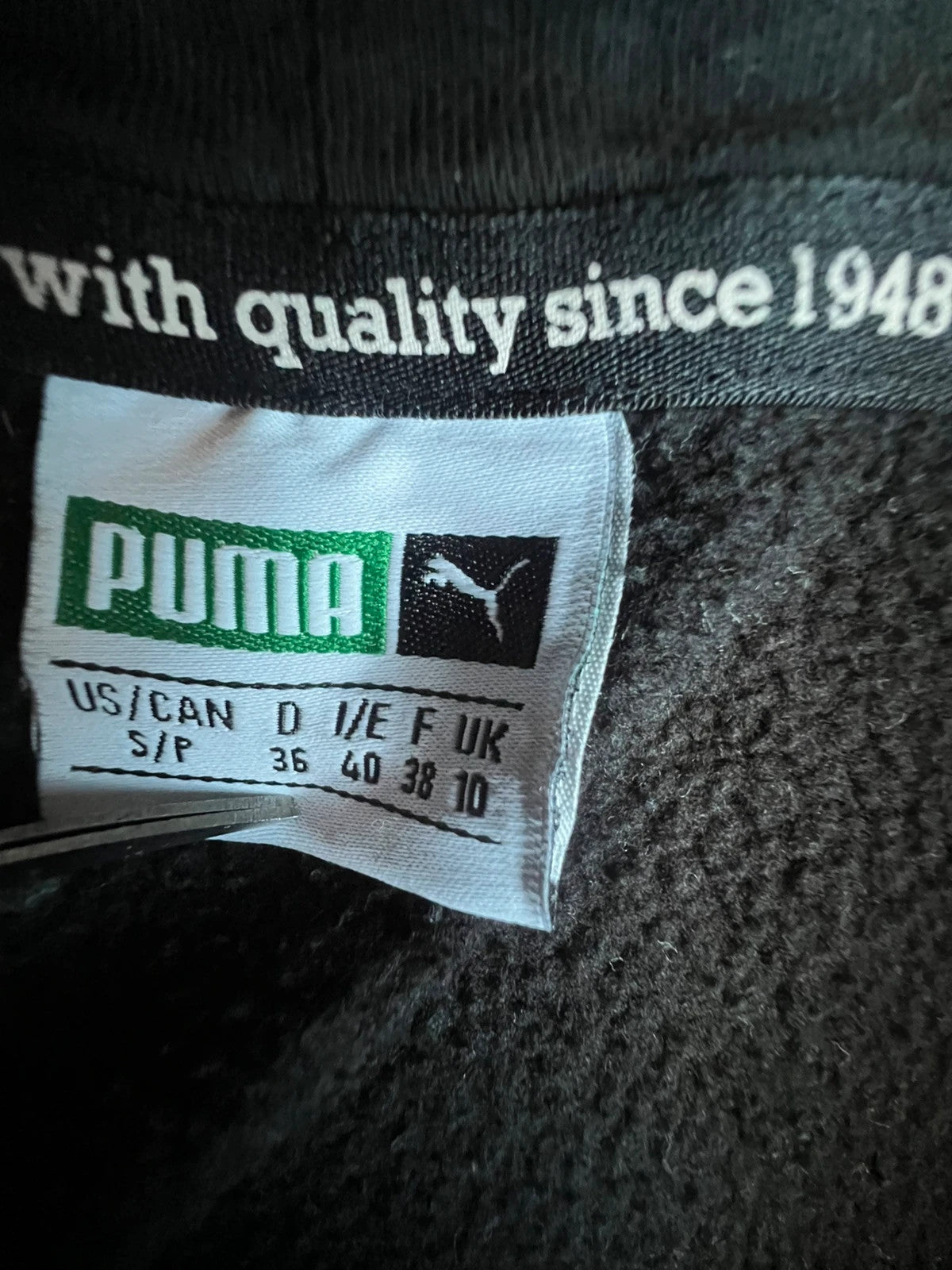 Puma black oversized hoodie with large cracked silver logo, vintage Y2K style.