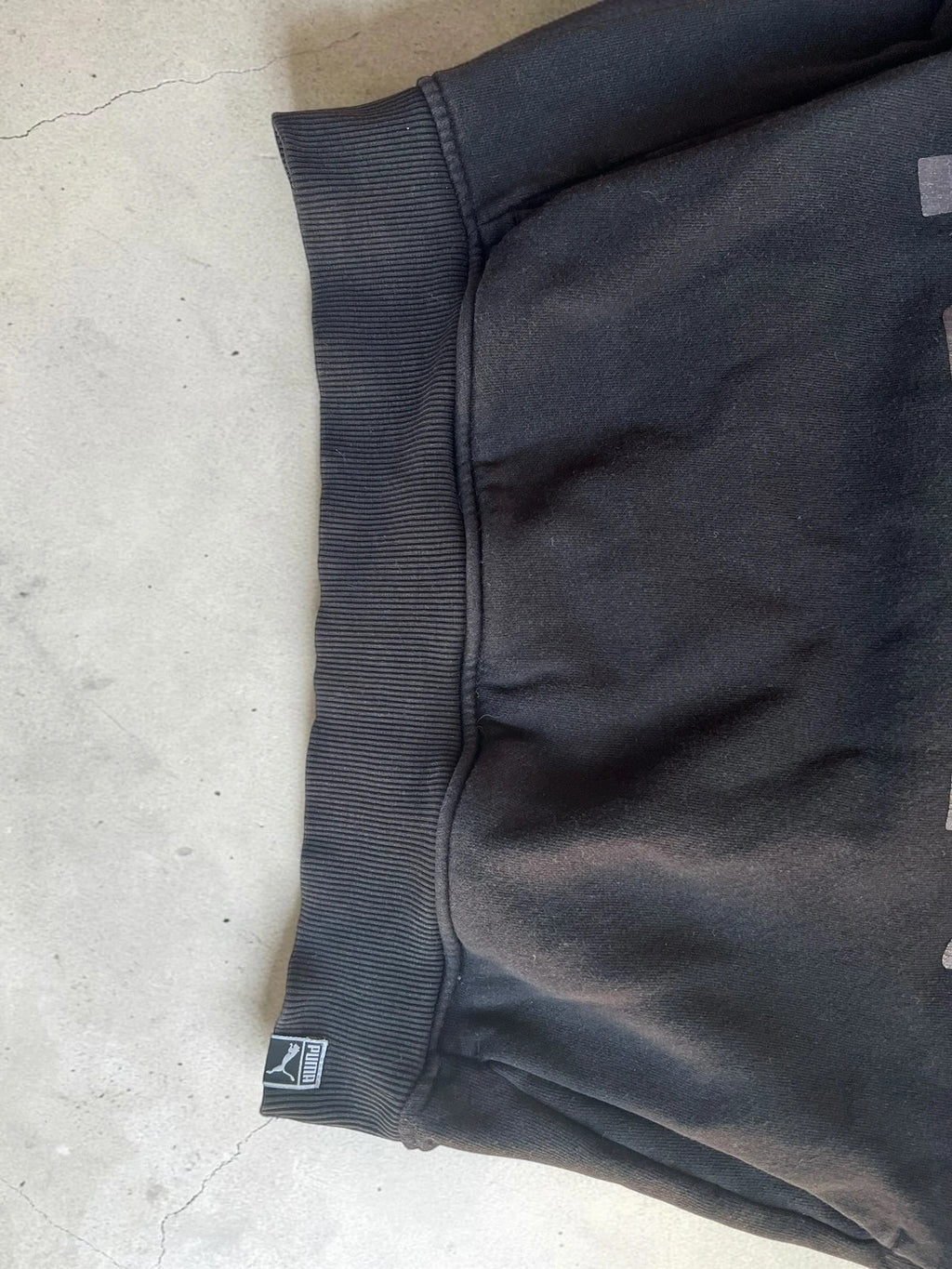Puma black oversized hoodie with large cracked silver logo, vintage Y2K style.