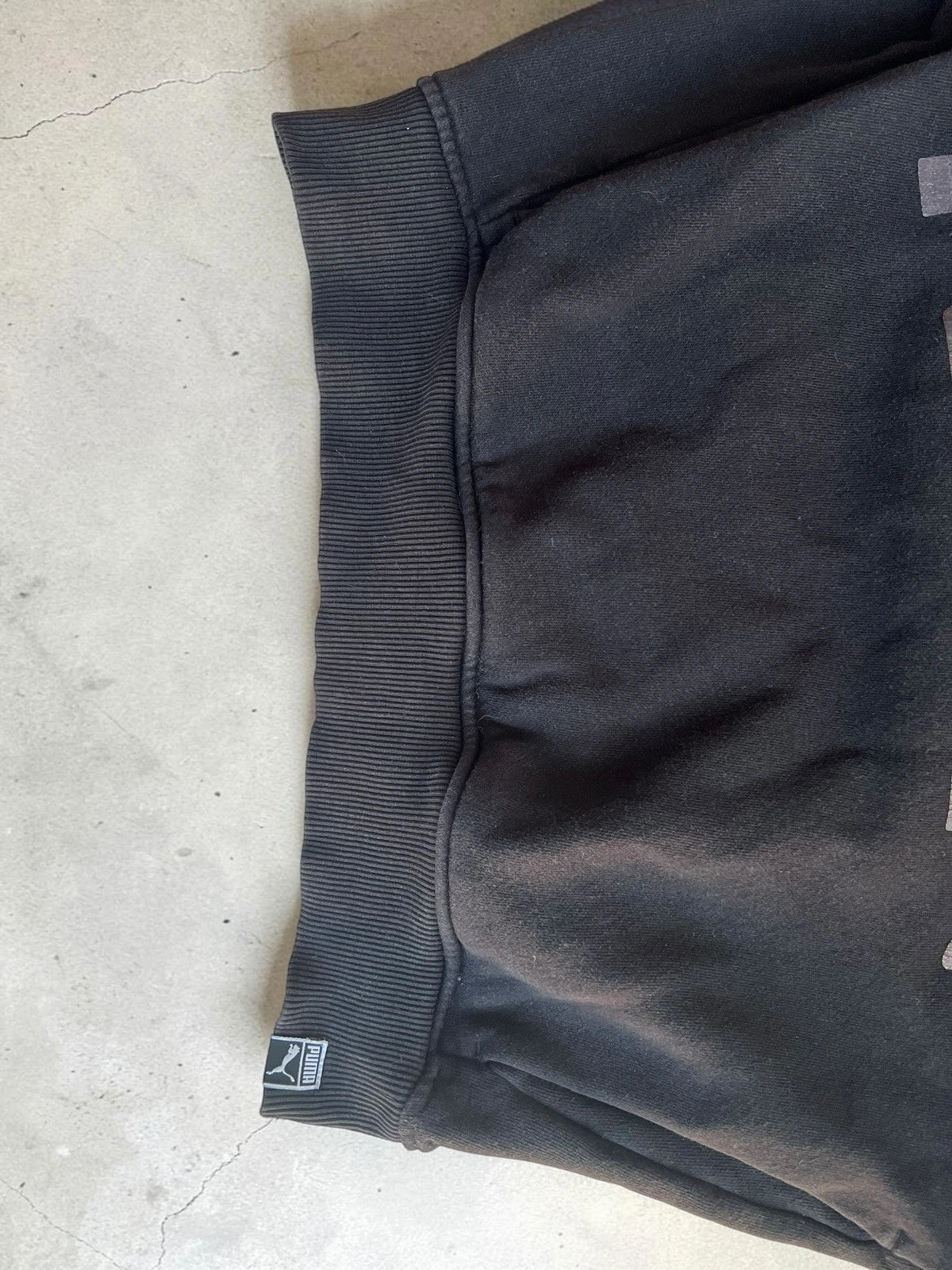 Puma black oversized hoodie with large cracked silver logo, vintage Y2K style.