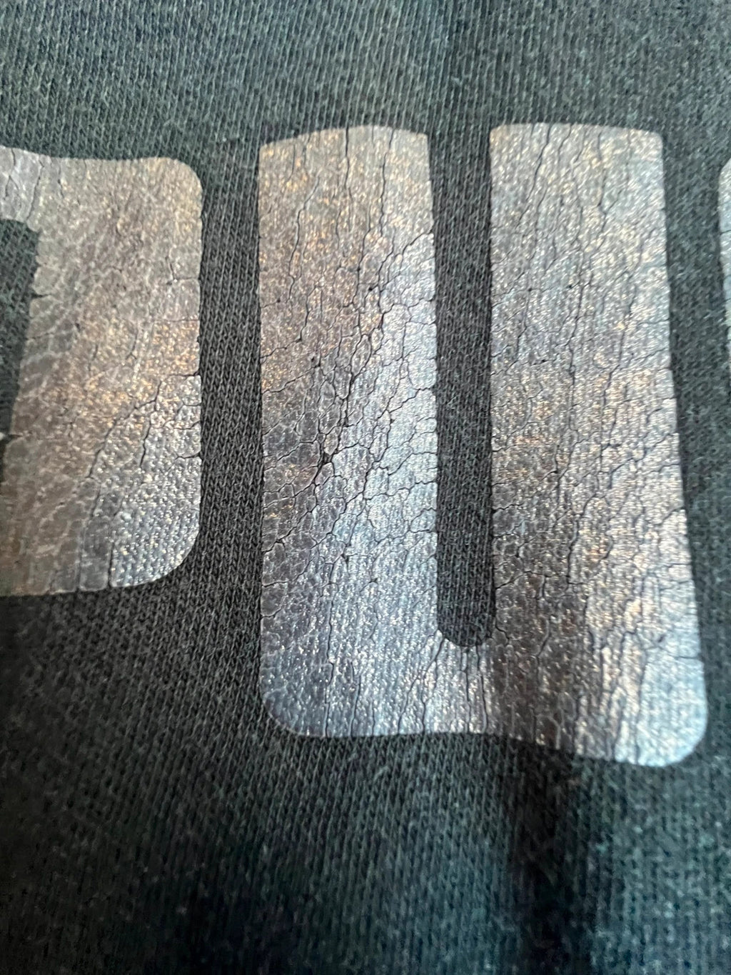Puma black oversized hoodie with large cracked silver logo, vintage Y2K style.